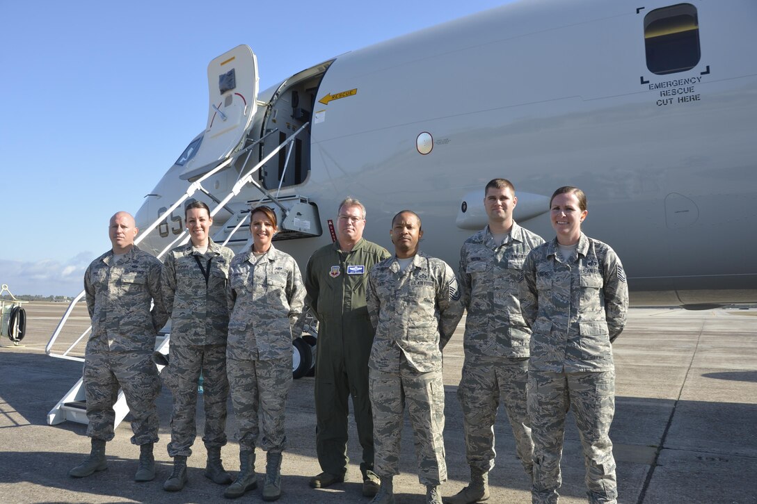 A cross section of military specialties to include operations, intelligence and communications, came together here March 14 for an incentive flight aboard a Navy P-8A Poseidon from Naval Air Station Jacksonville, Fla. March 14. The aircraft was here to present a working demonstration to Air Forces Northern leadership about the viability of using imagery-feed capabilities from the P-8A Poseidon during a Defense Support of Civil Authorities  event. From left: Master Sgt. Kevin Hale, intelligence; Capt. Renee Popoff, intelligence; Tech. Sgt. Tamara Murphy, communications; Maj. Jeffrey Rayhill, operations; Senior Master Sgt. Robert Gentry III, operations; Senior Airman Phillip Holzer, intelligence; and Tech. Sgt. Bridget Behrens, operations. While aboard, the Airmen, who each had a partial role in the larger demonstration effort, got to watch onboard operations during the flight. (Air Force  Photo Released/Mary McHale)