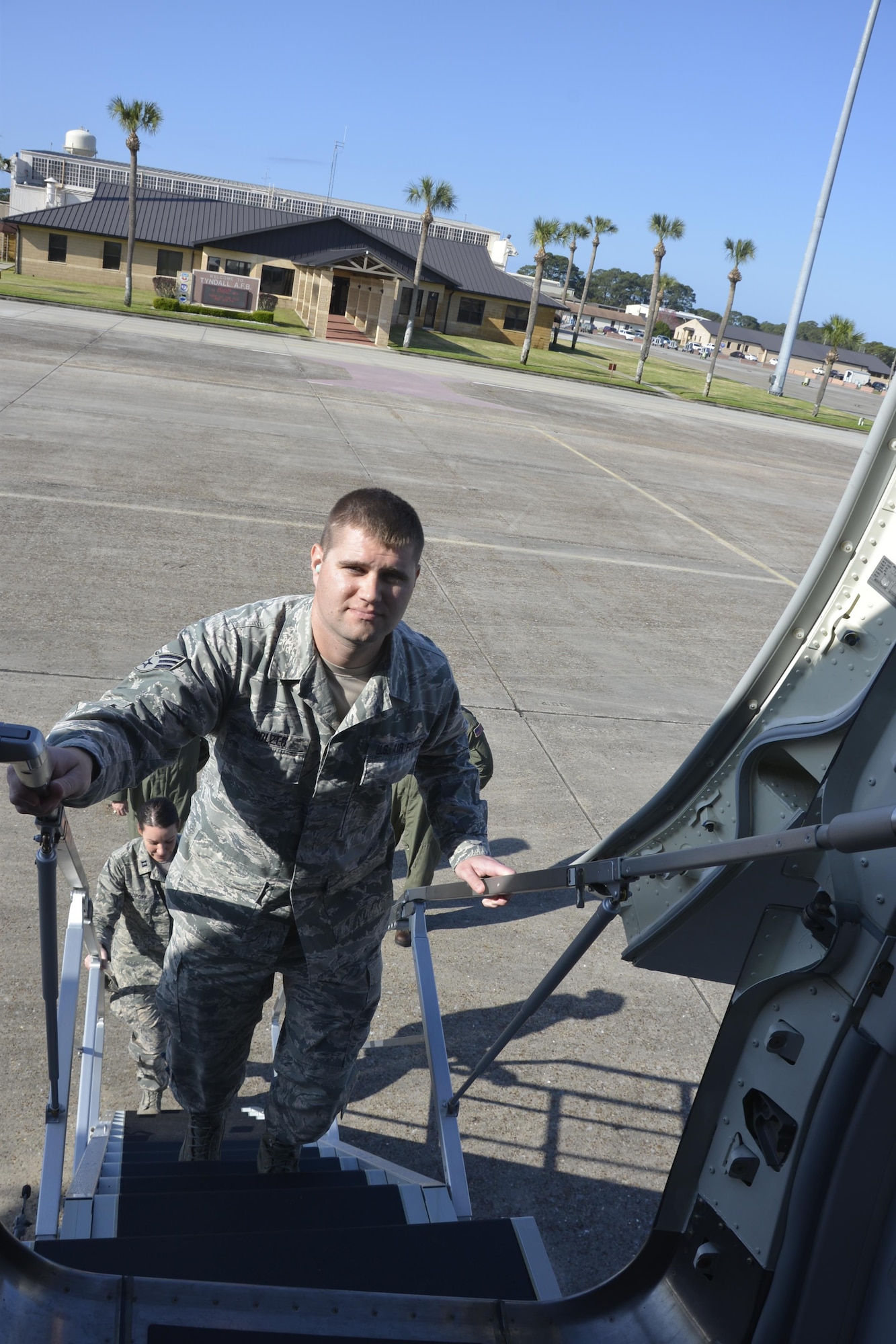 Senior Airman Phillip Holzer, an intelligence craftsman with the 601st Air Operations Center, climbs the stairs to board the P-8A Poseidon for an incentive flightMarch 14. The aircraft was here to present a working demonstration to Air Forces Northern leadership about the viability of using imagery feed from the platform during a Defense Support of Civil Authorities  event. He was one of seven Air Forces Northern Airmen selected for the flight.  While aboard, the Airmen, who each had a partial role in the larger demonstration effort, got to watch onboard operations during the flight. (Air Force  Photo Released/Mary McHale)