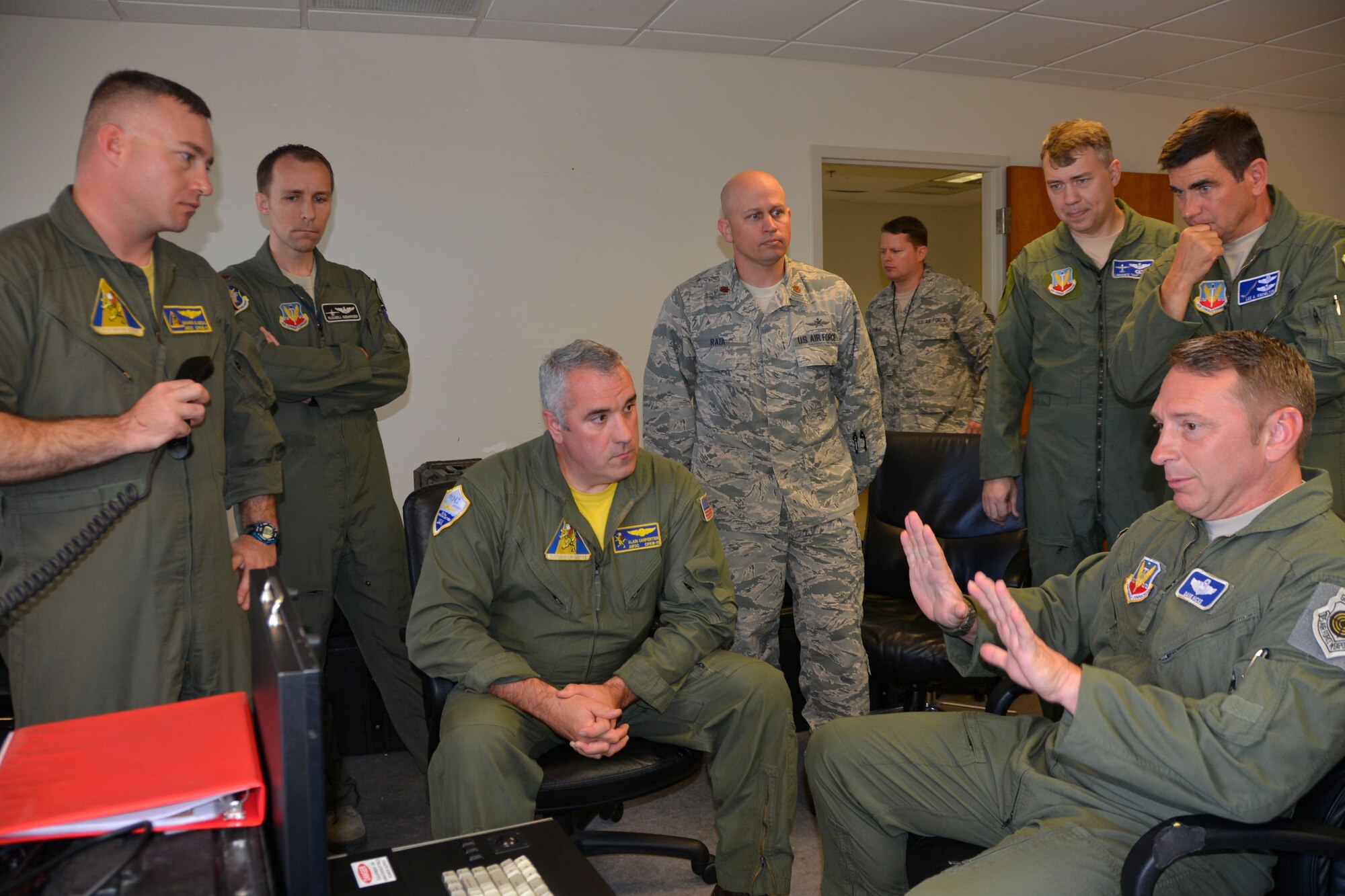 Chief Petty Officer Alain Carpenter, operations chief from NAS Jacksonville Tactical Operations Center, listens as Brig. Gen. David Hicks, Air Forces Northern Vice Commander, makes a point about the computer display generated from an airborne U.S. Navy P-8A Poseidon during a visual-imagery capability demonstration here March 14. The aircraft was here to present a working demonstration to Air Forces Northern leadership about the viability of using imagery feed from the platform during a Defense Support of Civil Authorities  event. Here, the P-8A Poseidon is generating real-time imagery as it flies in Northwest Florida airspace. Seven Airmen from Air Forces Northern flew aboard the aircraft during the demonstration to watch onboard operations during the flight. (Air Force  Photo Released/Mary McHale)