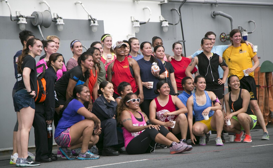 Marines and sailors pose for a group photo after participating in a Women's History Month 5K run aboard the USS Boxer in the Pacific Ocean, March 27, 2016. Marine Corps photo by Sgt. Briauna Birl