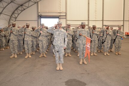 Soldiers from Alpha Company, 392nd ESB salute the American flag during the playing of the national anthem at a deployment ceremony on March 26, 2016 at Fort Meade, Md.