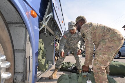 Soldiers load bags onto busses at the conclusion of a deployment ceremony held for the 392nd ESB on March 26, 2016 at Fort Meade, Md.