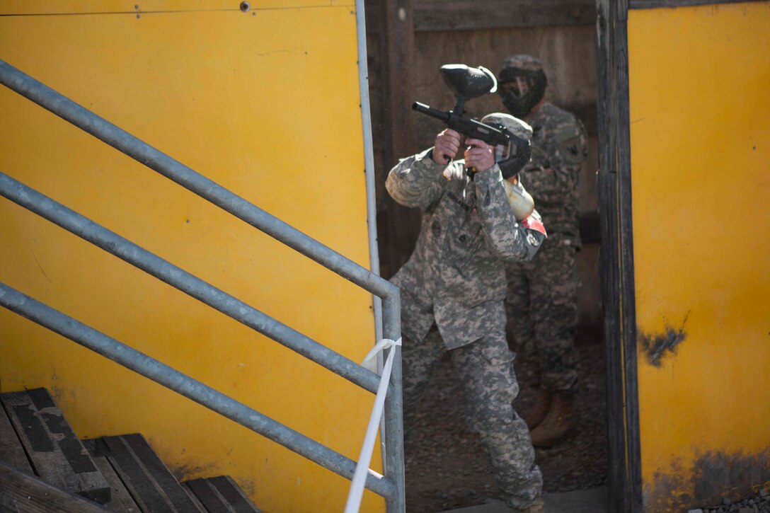 Joint Best Warrior Competition competitior U.S. Army  Sgt. First Class Anthony Bohanon of the Army Reserve Careers Division returns fire during the urban assault course March 22nd, 2016 at Ft. Knox, Kentucky. The Best Warrior Competition is a four-day competition that tests competitors' Army aptitude by going through urban warfare situations, board interviews, physical fitness tests, written exams, Warrior tasks and battle drills relevant to today's operational environment. (U.S. Army photo by Sgt. Amber Stephens)