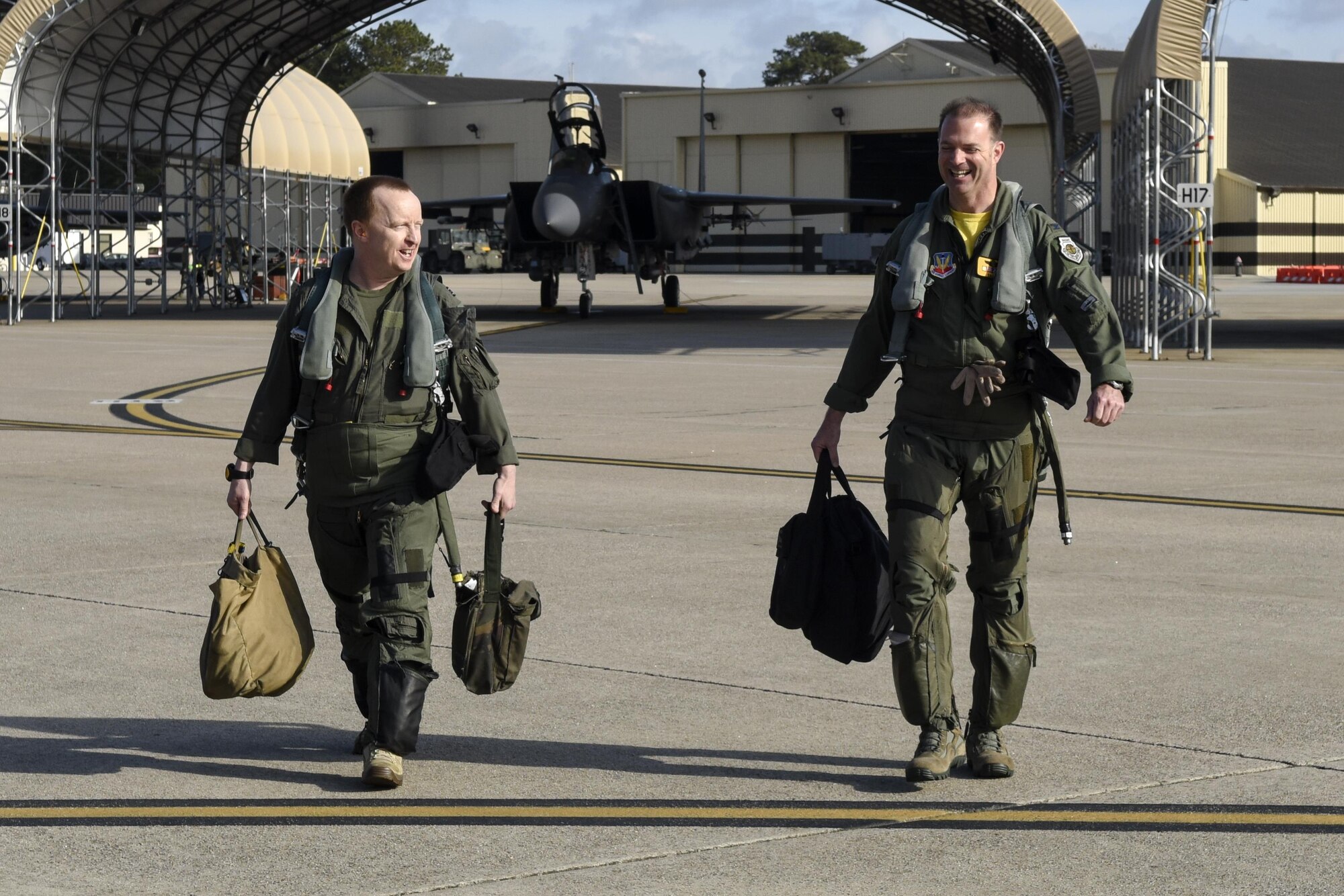 Royal Air Force Flt. Lt. Douglas McKay (left), assigned to the 336th Fighter Squadron pilot, walks with Col. Andrew Bernard, 4th Fighter Wing vice commander, towards an F-15E Strike Eagle to prepare for Razor Talon, March 25, 2016, at Seymour Johnson Air Force Base, North Carolina. Razor Talon is a monthly low-cost large-force training exercise for joint East Coast tactical and support aviation units. (U.S. Air Force photo/Airman Shawna L. Keyes) 