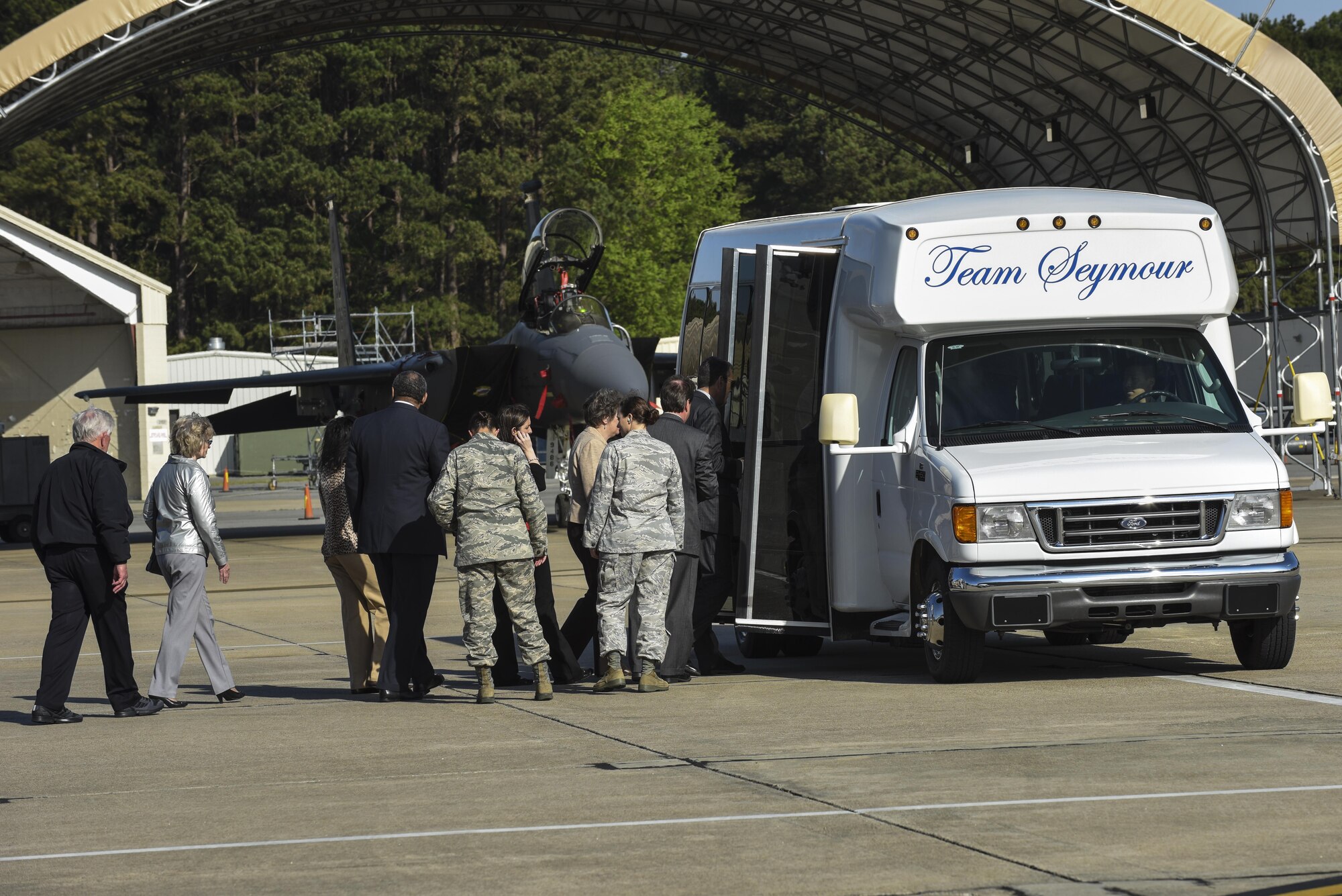 Community members board the bus after watching an F-15E Strike Eagle prepare to be launched, March 25, 2016, at Seymour Johnson Air Force Base, North Carolina. The group visited the 336th Fighter Squadron and a received a briefing about Razor Talon during their exercise orientation tour. (U.S. Air Force photo/Airman Shawna L. Keyes)