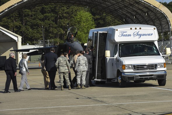 Community members board the bus after watching an F-15E Strike Eagle prepare to be launched, March 25, 2016, at Seymour Johnson Air Force Base, North Carolina. The group visited the 336th Fighter Squadron and a received a briefing about Razor Talon during their exercise orientation tour. (U.S. Air Force photo/Airman Shawna L. Keyes)