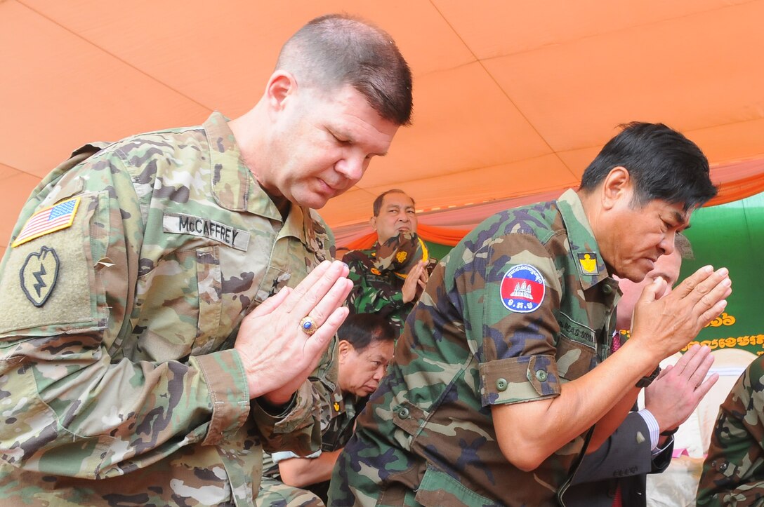 Army Maj. Gen. Todd McCaffrey, deputy commander of U.S. Army Pacific, and Royal Cambodian Army Gen. Meas Sophea, bow during a Buddhist blessing at the closing ceremonies for Angkor Sentinel 2016 at the Training School for Multinational Peacekeeping Forces in Kampong Speu Province, Cambodia, March 25, 2016. Army photo by Master Sgt. Mary E. Ferguson