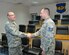 Maj. Gen. Andrew Mueller, Air Force Chief of Safety and AF Safety Center commander, coins Tech. Sgt. Lucas Long, 386th Air Expeditionary Wing Weapons Safety NCO in charge, at an undisclosed location in Southwest Asia March 18, 2016. Long received the 2015 Air Force Chief of Safety Outstanding Achievement Award for Weapons Safety which recognizes Airmen who have made significant contributions and achievements to the Air Force's explosive safety program. (U.S. Air Force photo by Master Sgt. Kevin Nichols)