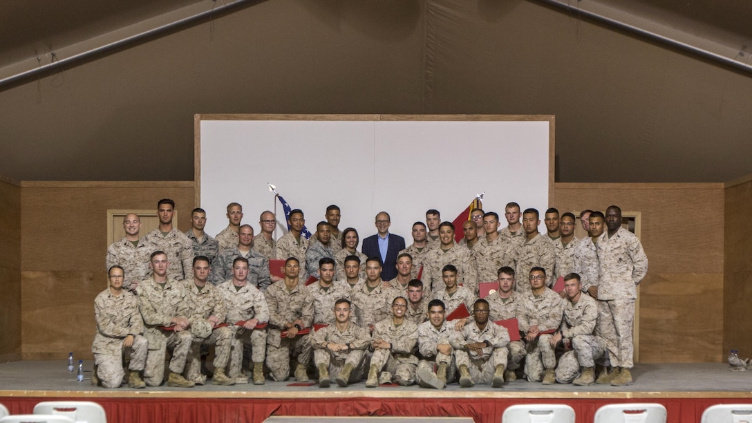 Ambassador Douglas A. Silliman, back center, the U.S. Ambassador to Kuwait, takes a group photo with the Special Purpose Marine Air Ground Task Force-Crisis Response-Central Command Corporals Course staff and graduates in Kuwait on March 25, 2016. The corporals’ leadership program is designed to provide instruction for tasks developed in accordance with Marine Corps Order 1510.90, Individual Training Standards. Corporals Course is a professional military education requirement for all corporals to complete in order to be qualified for promotion.