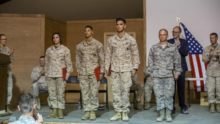 The distinguished graduates of the Special Purpose Marine Air Ground Task Force-Crisis Response-Central Command's Corporals Course are recognized for their achievements during their graduation ceremony in Kuwait on March 25, 2016. The corporals’ leadership program is designed to provide instruction for tasks developed in accordance with Marine Corps Order 1510.90, Individual Training Standards. Corporals Course is a professional military education requirement for all corporals to complete in order to be qualified for promotion.
