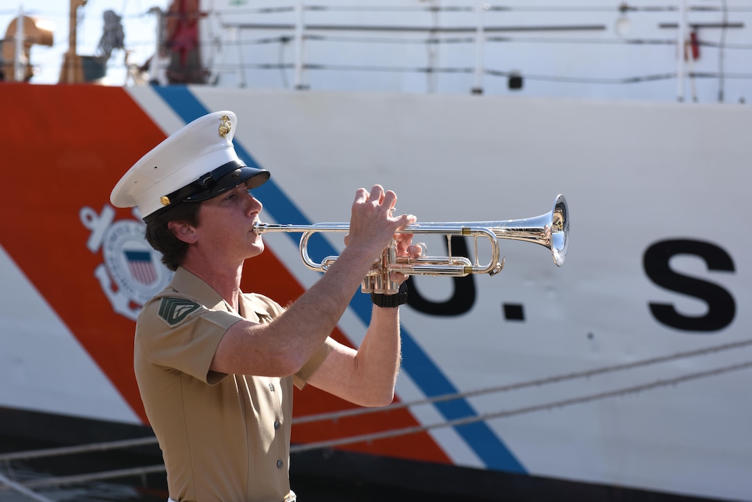 A member of the Marine Band San Diego plays retreat during the closing moments of the decommissioning ceremony for the Coast Guard Cutter Boutwell at Naval Base San Diego, March 16, 2016. Boutwell was decommissioned after 47 years of service. Coast Guard photo by Petty Officer 3rd Class Joel Guzman