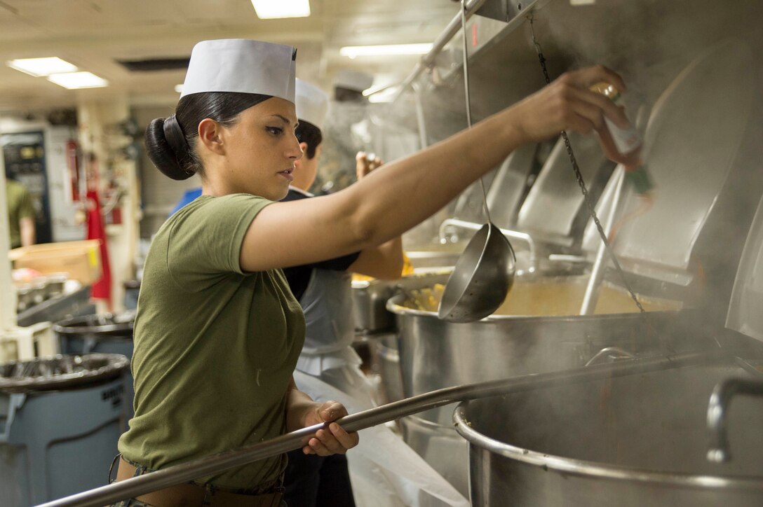 Marine Corps Cpl. Albina Camaj prepares meals in the main galley aboard the USS Bonhomme Richard in the East Sea, March 18, 2016. Camaj is a food service specialist assigned to Marine Medium Tiltrotor Squadron 265. Navy photo by Petty Officer 3rd Class Jeanette Mullinax