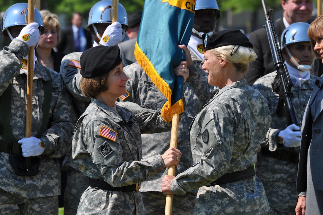 Army Maj. Gen. Camille M. Nichols accepts the U.S. Army Contracting Command flag from Gen. Ann Dunwoody, Army Materiel Command commanding general, during an assumption-of-command ceremony at Redstone Arsenal, Ala., May 17, 2012. Nichols served as the contracting command’s first commanding general. Army photo
