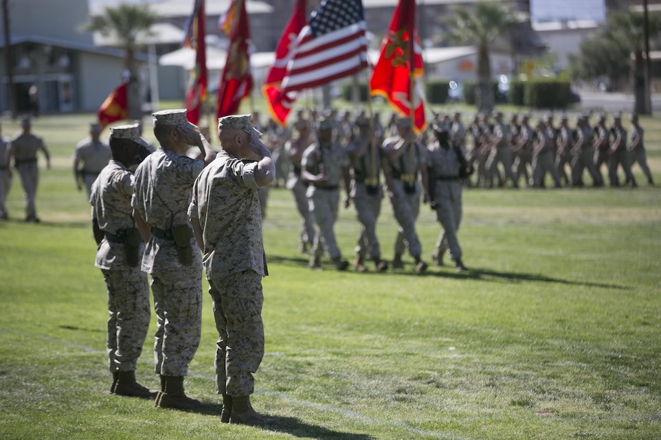 Col. William Vivian, commanding officer, Sgt. Maj. Edward Zapata, oncoming sergeant major, and Sgt. Maj. Rodney Lane, outgoing sergeant major, 7th Marine Regiment, salute the National Colors during the pass in review portion of the regiment’s relief and appointment ceremony at Lance Cpl. Torrey L. Gray field, March 18,2016. (Official Marine Corps Photo by Cpl. Julio McGraw/Released)