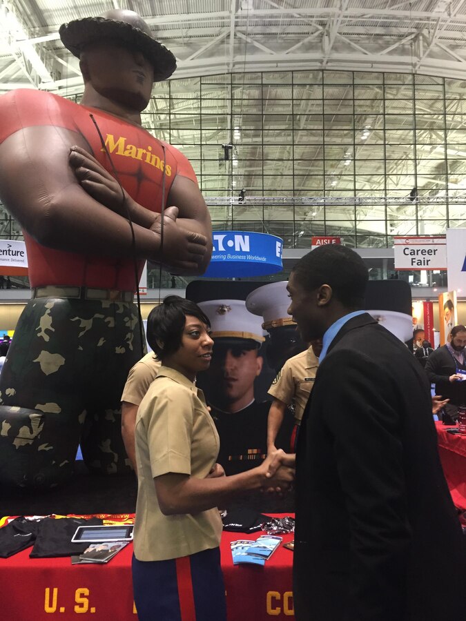 Marines of Recruiting Station Portsmouth, New Hampshire, engage attendees of the National Society of Black Engineers convention about careers and opportunities in the Marine Corps at the Boston Convention Center, March 24. NSBE is a student-run organization focused on the employment of minority engineers from across the country. The Marines set up in the career fair part of the convention as well as aiding in resume creating and running morning workout sessions with interested students.