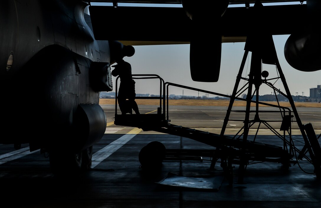 A member of the 374th Maintenance Squadron loosens a bolt on the side of an U.S. Air ForceeMC-130 Talon II at Yokota Air Base, Japan, Feb. 19, 2016. Aircraft enter the phase docks for an inspection every 540 days for a 14 to 16-day inspection and to be repaired. (U.S. Air Force photo by Senior Airman David Owsianka/Released)