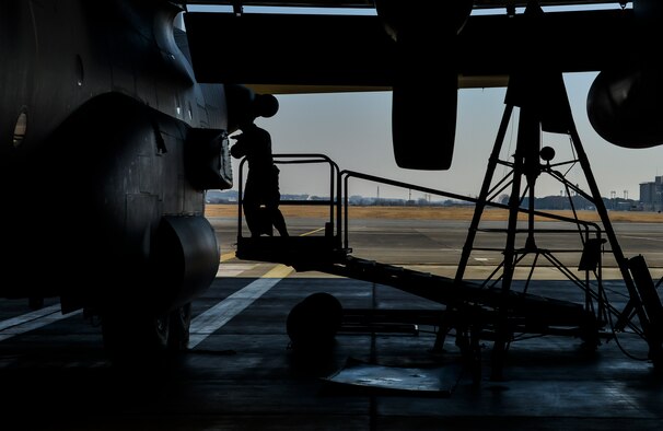 A member of the 374th Maintenance Squadron loosens a bolt on the side of a MC-130 Talon II at Yokota Air Base, Japan, Feb. 19, 2016. Aircraft enter the phase docks for an inspection every 540 days for a 14- to 16-day inspection and to be repaired. (U.S. Air Force photo/Senior Airman David Owsianka)