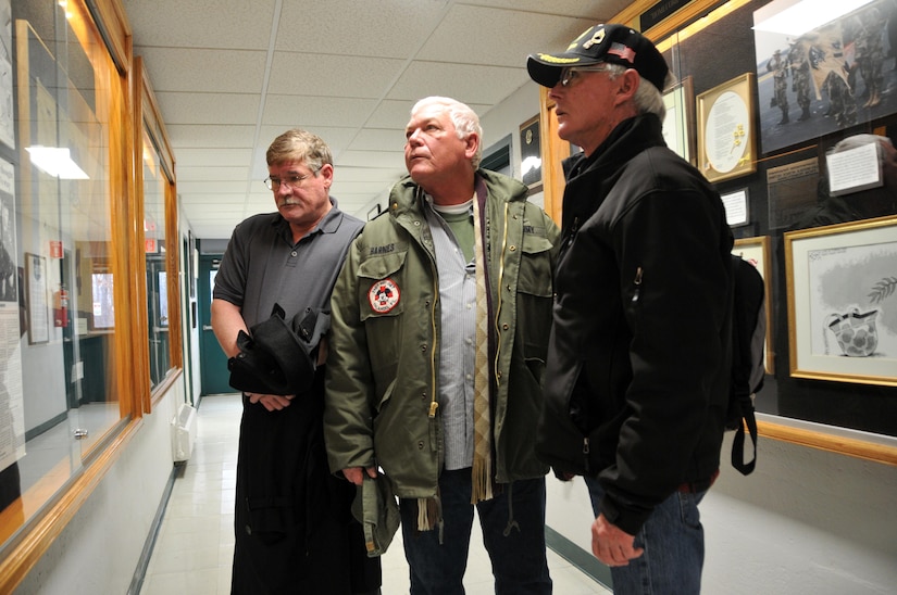 Former Army Reserve Soldiers Michael O’Toole, Russell Barnes and Russell Dearing, from left, review the Greensburg Army Reserve Center’s artifacts related to the Feb. 21, 1991 Scud missile attack against Dhahran, Saudi Arabia that killed 13 and wounded 43 Soldiers of the Army Reserve’s 14th Quartermaster Detachment. The trio carried out medevac and other life-saving missions in the immediate aftermath of that single-most devastating attack against allied forces during the Gulf War.