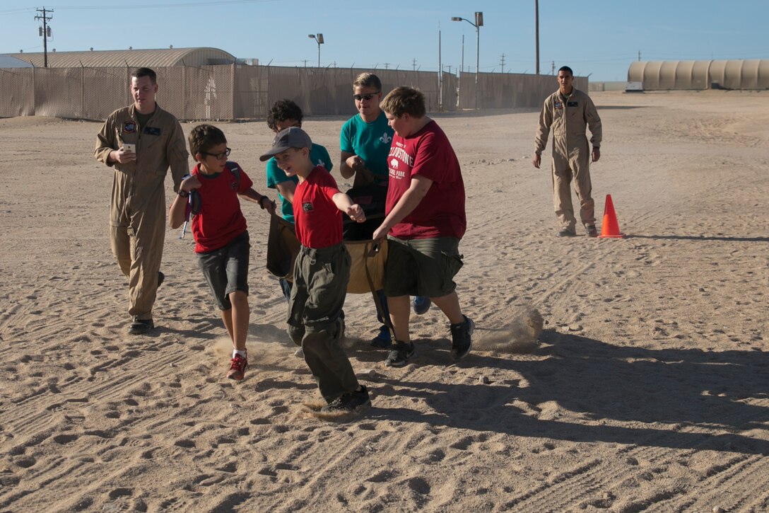 Boy scouts with Troop 180 perform a medical evacuation drill under the supervision of Marines from Marine Wing Support Squadron 374 during a Boy Scout Camp Out at Camp Wilson, March 19, 2016. (Official Marine Corps photo by Cpl. Medina Ayala-Lo/Released)