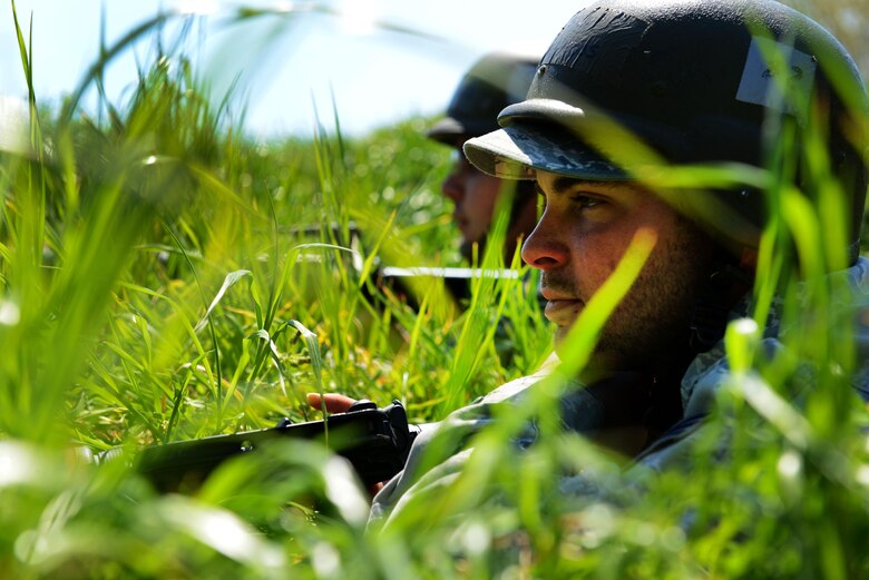 U.S. Air Force Senior Airmen Skyler Moss and Remzo Rovcanin, 20th Civil Engineer Squadron heating, ventilation, and air conditioning technicians, lay in the prone position with their weapons ready during operational readiness exercise Weasel Victory 16-08 at Shaw Air Force Base, S.C., March 23, 2016. OREs, held several times annually, provide 20th Fighter Wing Airmen an opportunity to demonstrate their combat capabilities and emergency preparedness. (U.S. Air Force photo by Airman 1st Class Destinee Dougherty)
