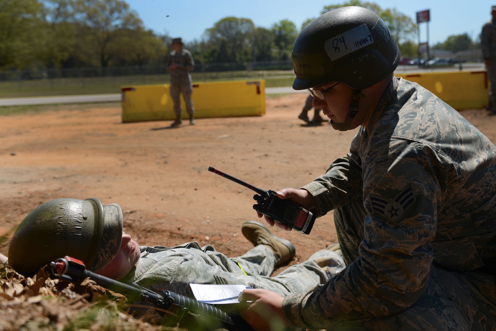 U.S. Air Force Senior Airman Remzo Rovcanin, 20th Civil Engineer Squadron heating, ventilation, and air conditioning technician, kneels over an injured comrade after a simulated improvised explosive device explosion during operational readiness exercise Weasel Victory 16-08 at Shaw Air Force Base, S.C., March 23, 2016. Rovcanin called in 20th Security Forces Squadron Airmen to help secure the area before buddy-carrying his wingman to a safe location. The simulated attack tested the Airmen’s buddy-care skills and ability to subdue an armed combatant. (U.S Air Force photo by Airman 1st Class Destinee Dougherty)