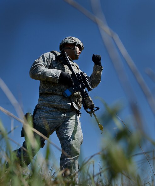 U.S Air Force Airman Julian Arnold, 20th Security Forces Squadron base defense operations center controller, calls his formation to a halt during operational readiness exercise Weasel Victory 16-08 at Shaw Air Force Base, S.C., March 22, 2016. The exercise is part of necessary training to provide combat ready Airmen and air power to combatant commanders downrange. (U.S. Air Force photo by Senior Airman Michael Cossaboom)