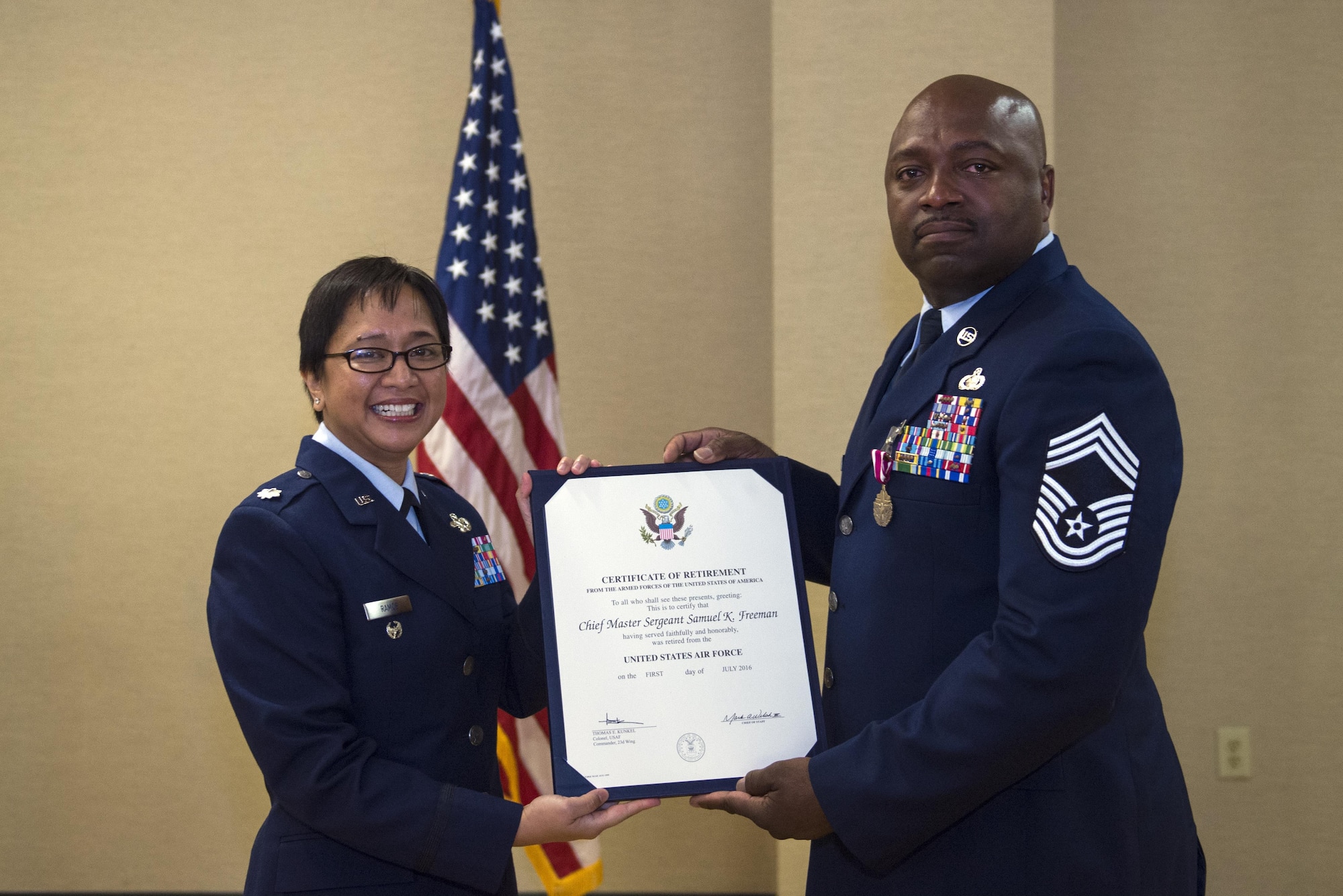 U.S. Air Force Lt. Col. Laura Ramos, former 23d Logistics Readiness Squadron commander, presents Chief Master Sgt. Samuel Freeman, 23d LRS chief enlisted manager, with a retirement certificate, March 25, 2016, at Moody Air Force Base, Ga. Freeman was responsible for balancing approximately 370 manpower authorizations and establishing 131 unit type codes enabling the deployment of  nearly 100 logisticians; the most in two years. (U.S. Air Force photo by Airman 1st Class Greg Nash/Released)
