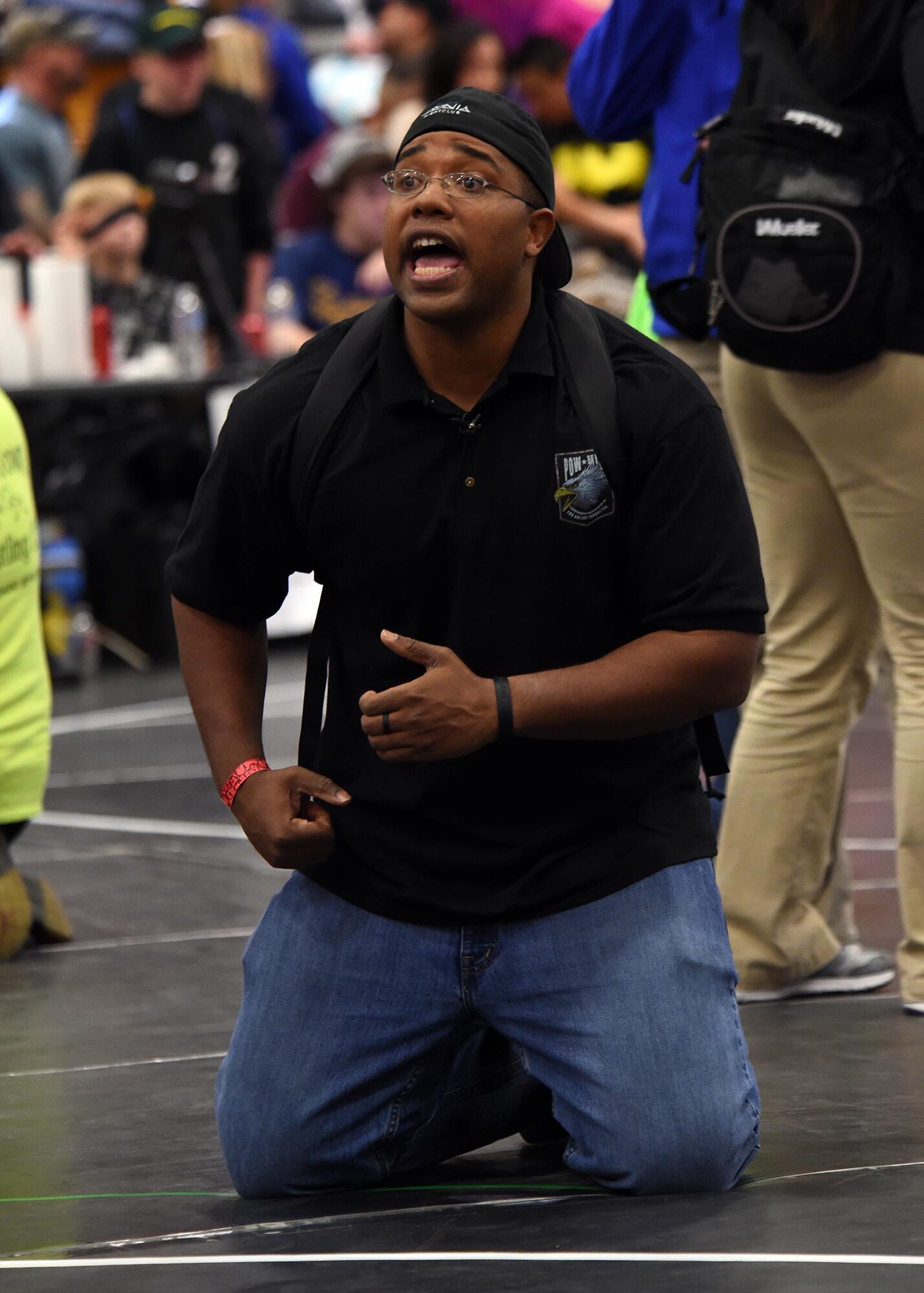 Staff Sgt. Morris Thomas, the Children of Valor wrestling team coach, instructs a wrestler during a match at the state wrestling competition in Castle Rock, Colo., Feb. 28, 2016. Thomas used wrestling as a guide while going through tough times during his youth. He now shares that sentiment with his wrestling team. (U.S. Air Force photo/Staff Sgt. Deborah Lockhart)