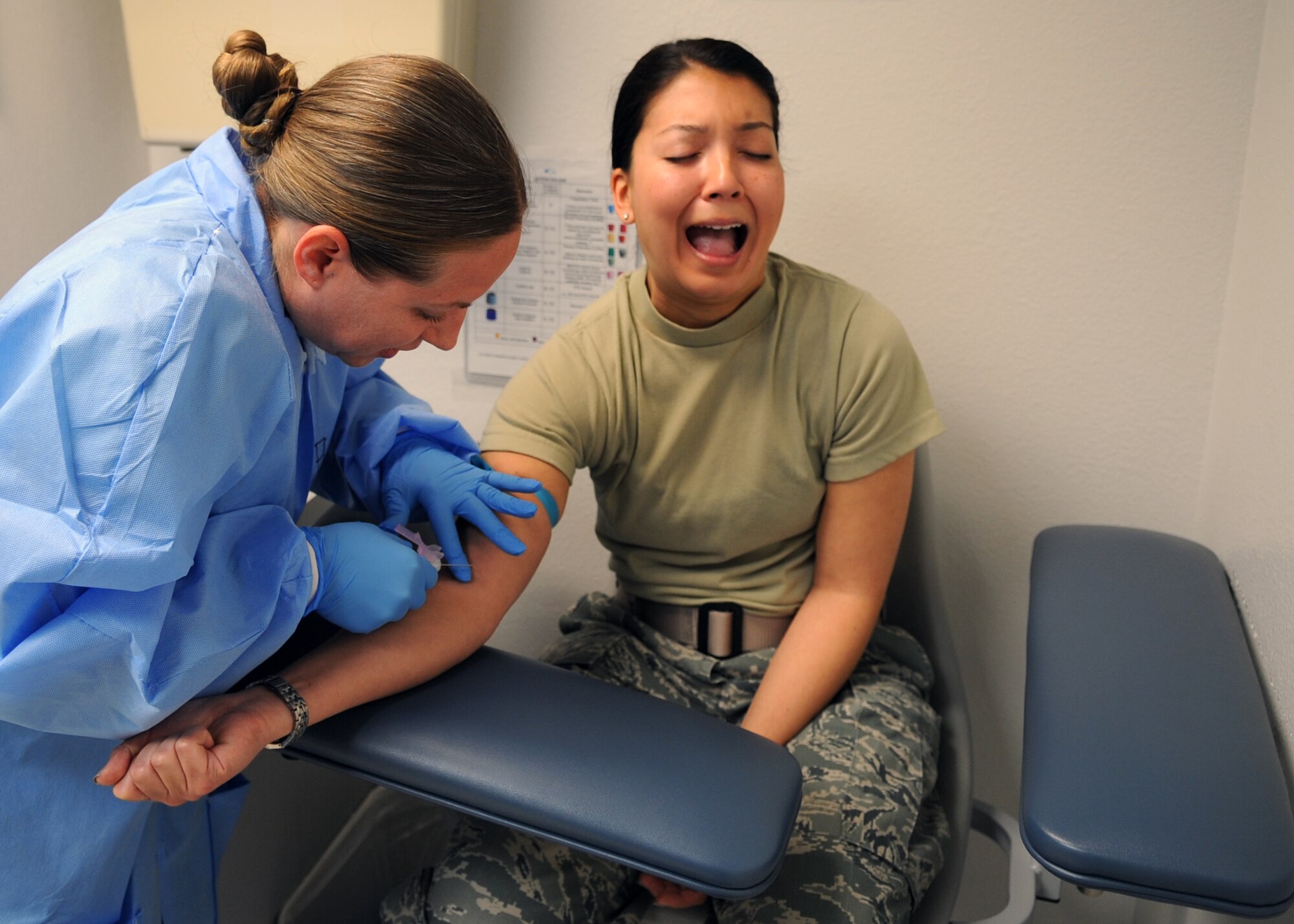 U.S. Air Force Tech. Sgt. Angela Flores, 489th Bomb Group laboratory technician, left, draws blood from Capt. Stephanie Guyette, 489th BG intelligence officer, March 20, 2016, at Dyess Air Force Base, Texas. Guyette is new to the 489th BG and spent her first reserve weekend completing her public health assessment. (U.S. Air Force photo by Senior Airman Shannon Hall/Released)