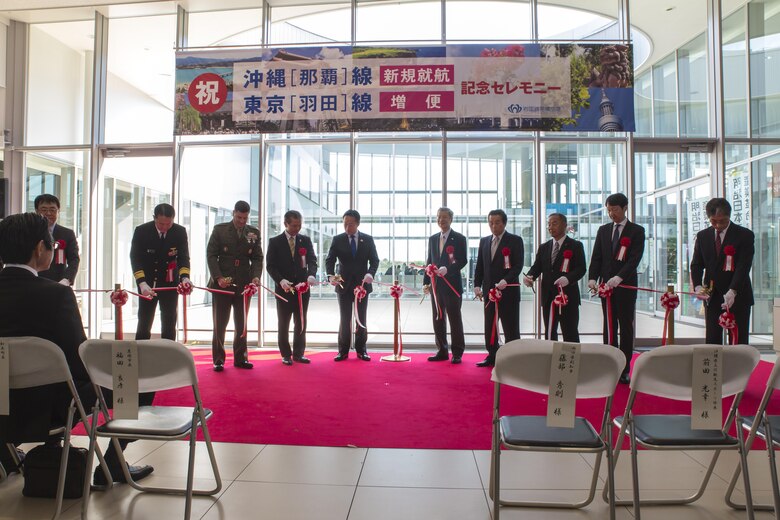 The Iwakuni Kintaikyo Airport Use Promotion Council and distinguished guests celebrate the addition of two new flights to the Iwakuni Kintaikyo Airport by cutting a ribbon March 27, 2016. The celebration also included an Eisaa Okinawa Drum Demonstration, a Ryuky-Koku-Matsuri Daiko Drum performance. Distinguished guests expressed their appreciation toward the Ministry of Defense, Ministry of Land, Infrastructure, and Transport, MCAS Iwakuni and other organizations involved in the adoption of these new flights. The airport and additional flights will contribute to the exchange of people and culture among Iwakuni, Okinawa and other countries in the region. (U.S. Marine Corps photo by Sgt. Antonio J. Rubio/Released)