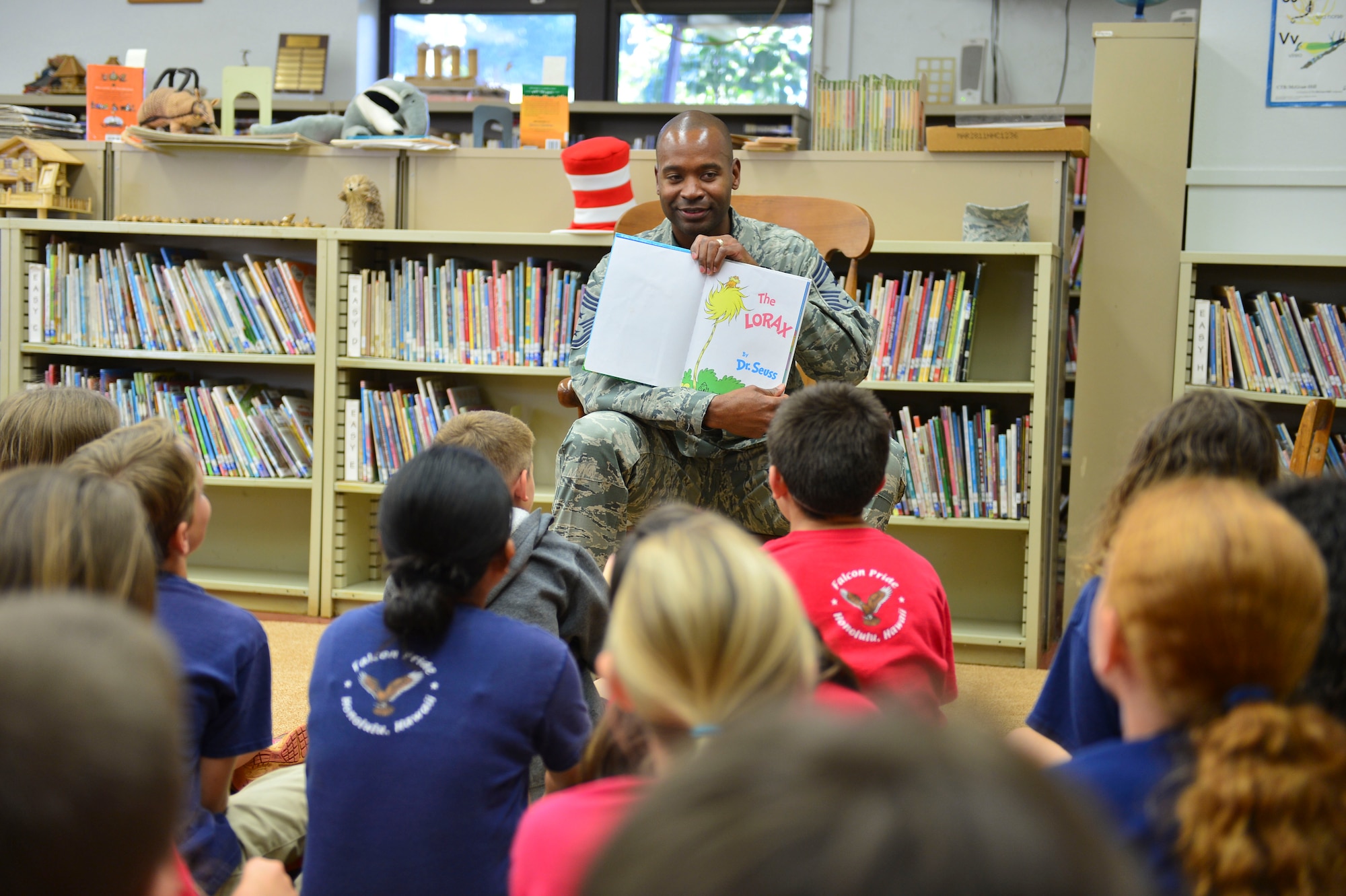 Chief Jerry Williams, 15th Wing command chief, reads ‘The Lorax’ to a group of students at Hickam Elementary School on Joint Base Pearl Harbor-Hickam, Hawaii, March 3, 2016. Williams read to the students as part of the school’s Read Across America event which took place March 1-4. Read Across America is a national program that focuses on motivating students to read through events, partnerships and reading resources. (U.S. Air Force photo by Tech. Sgt. Aaron Oelrich) 