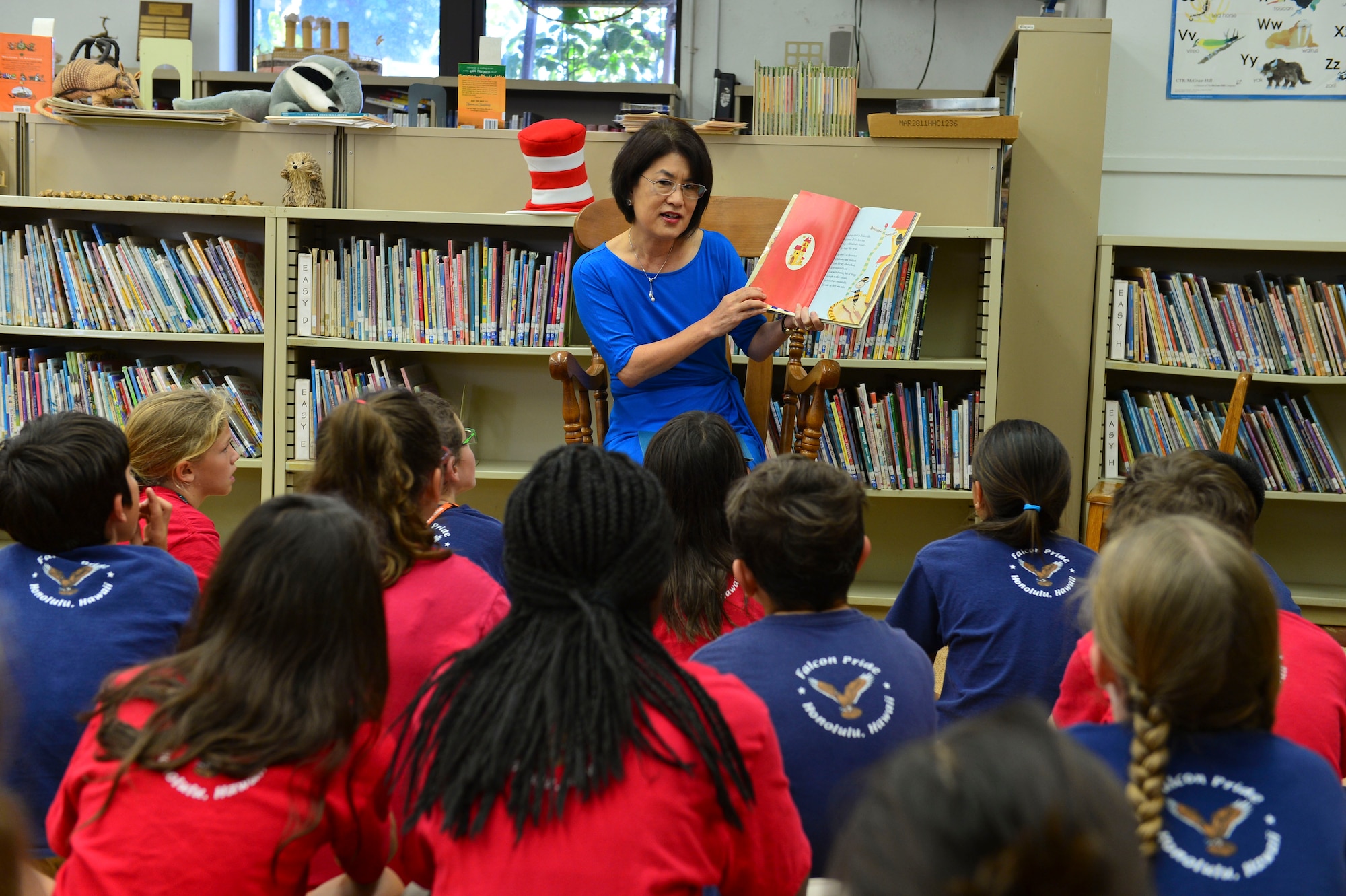 Dawn Amano, first lady of Hawaii, reads a book to a group of students at Hickam Elementary School March 3, 2016 on Joint Base Pearl Harbor-Hickam, Hawaii. Amano read to the students as part of the school’s Read Across America event which took place March 1-4. Read Across America is a national program that focuses on motivating students to read through events, partnerships and reading resources. Throughout the week, the school also honored renowned children’s book author Dr. Seuss, whose birthday was March 2. (U.S. Air Force photo by Tech. Sgt. Aaron Oelrich) 