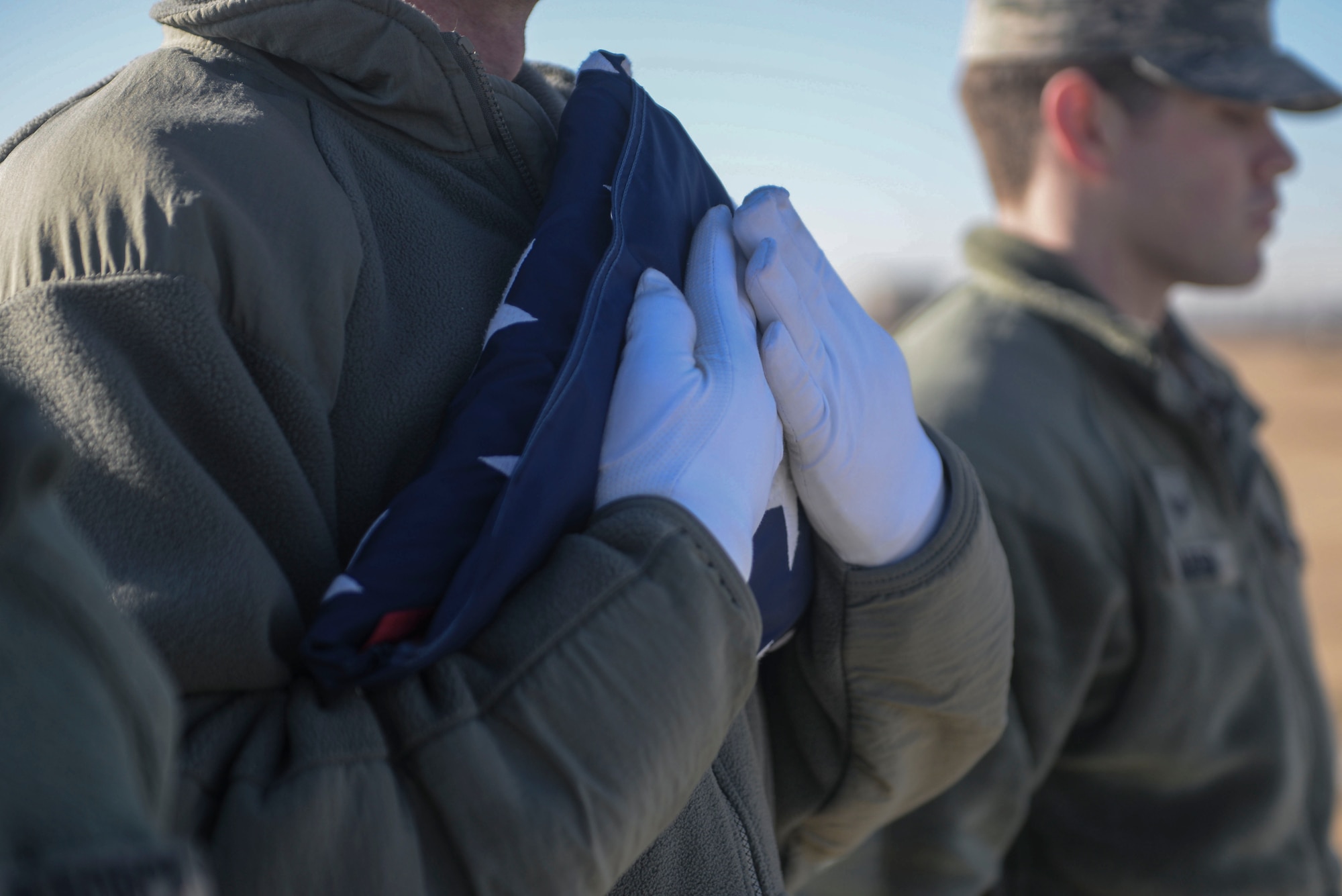 Members of the Honor Guard secure the flag during practice at Minot Air Force Base, N.D., March 10, 2016. The core mission of the United States Air Force Honor Guard is to provide military funeral honors to veterans and retirees of the Air Force. (U.S. Air Force photo/Airman 1st Class Jessica Weissman)