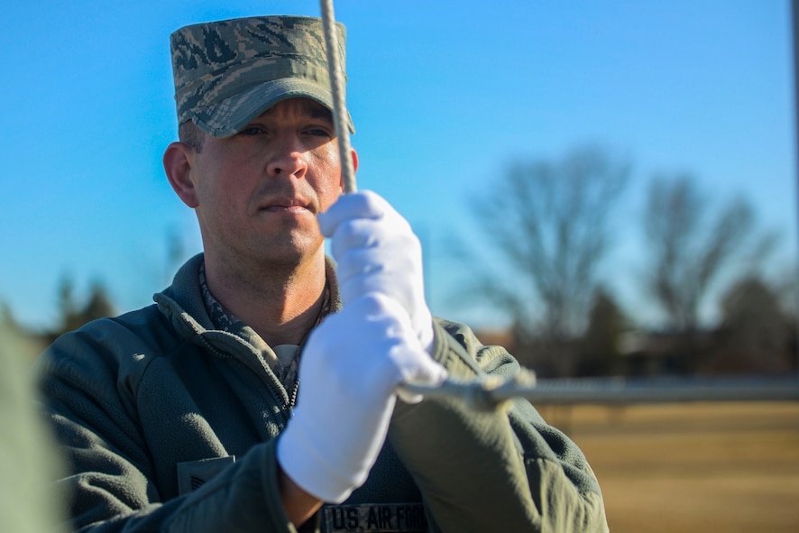 Tech. Sgt. Joshua Hull, the program manager of the Honor Guard, holds the halyard during a practice at Minot Air Force Base, N.D., March 10, 2016. Hull says the most rewarding thing from being a guardsman is gaining a deeper respect for military traditions. (U.S. Air Force photo/Airman 1st Class Jessica Weissman)