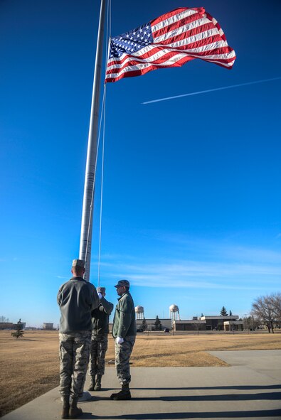 Members of the Honor Guard raise the flag during practice at Minot Air Force Base, N.D., March 10, 2016. The core mission of the United States Air Force Honor Guard is to provide military funeral honors to veterans and retirees of the Air Force. (U.S. Air Force photo/Airman 1st Class Jessica Weissman)
