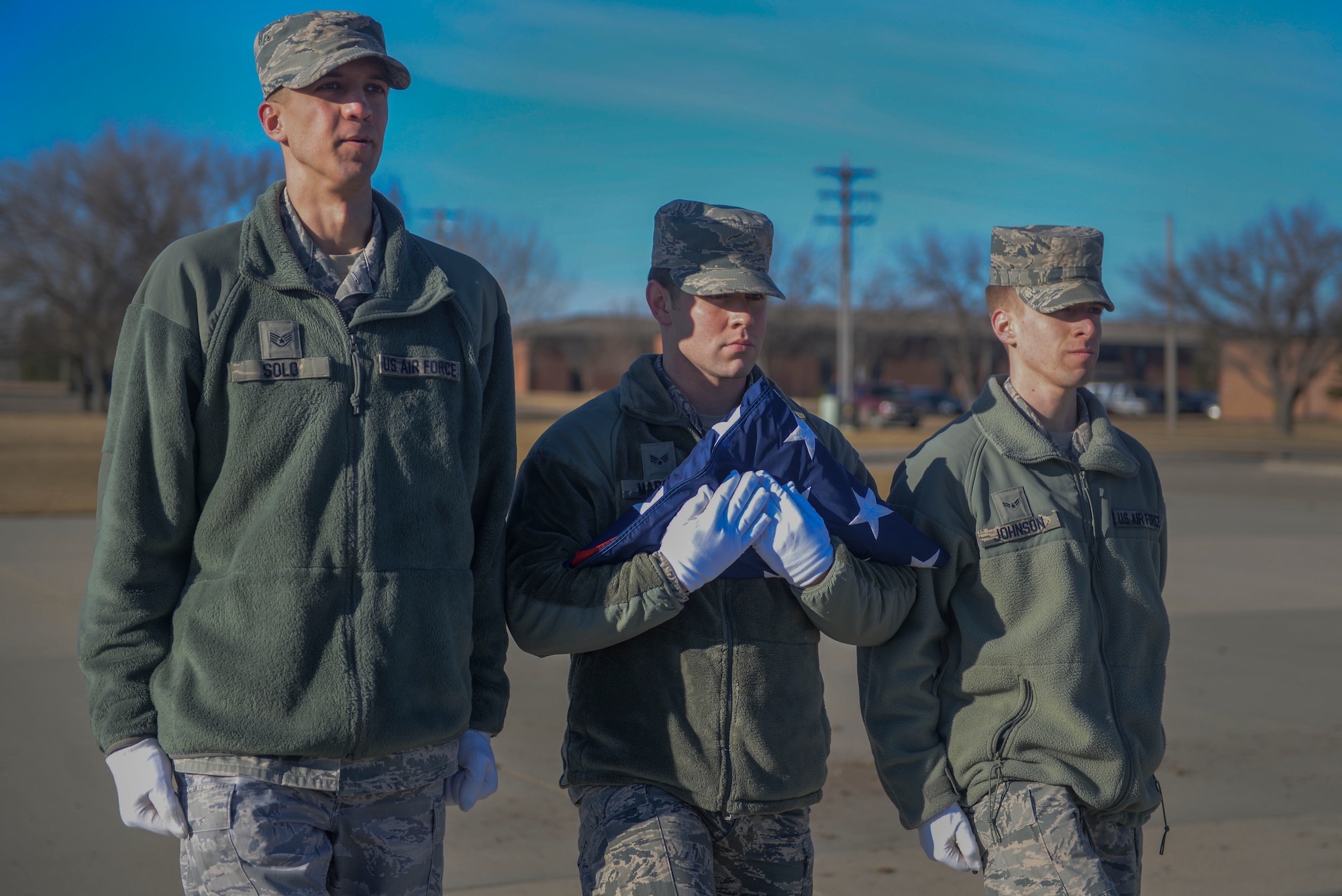 Members of the Honor Guard secure the flag during practice at Minot Air Force Base, N.D., March 10, 2016. The core mission of the United States Air Force Honor Guard is to provide military funeral honors to veterans and retirees of the Air Force. (U.S. Air Force photo/Airman 1st Class Jessica Weissman)