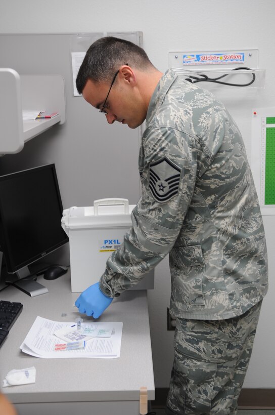 U.S. Air Force Master Sgt. Wade Melick, 489th Aerospace Medicine Squadron healthcare administrator, gets medical supplies together, March 20, 2016, at Dyess Air Force Base, Texas. Melick is an Air Reserve Technician who works full-time as a civil service employee for the Air Force and also as a military member for the Air Force Reserve Command. (U.S. Air Force photo by Senior Airman Shannon Hall/Released)