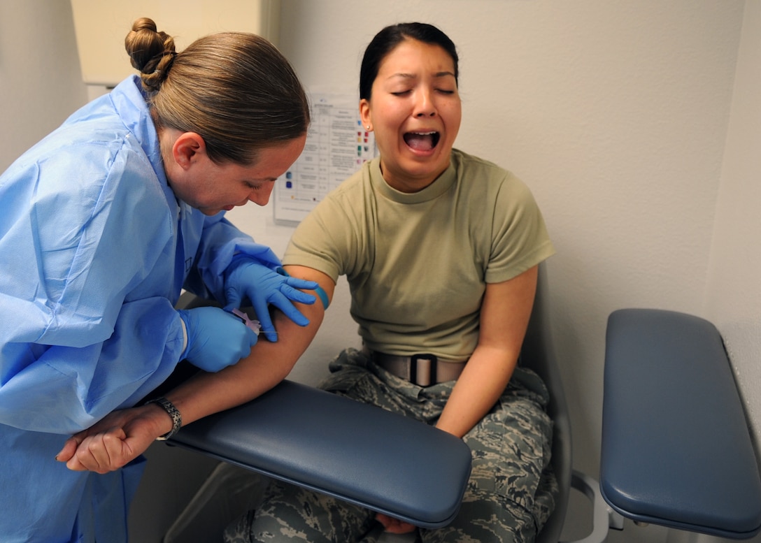 U.S. Air Force Tech. Sgt. Angela Flores, 489th Bomb Group laboratory technician, left, draws blood from Capt. Stephanie Guyette, 489th BG intelligence officer, March 20, 2016, at Dyess Air Force Base, Texas. Guyette is new to the 489th BG and spent her first reserve weekend completing her public health assessment. (U.S. Air Force photo by Senior Airman Shannon Hall/Released) 