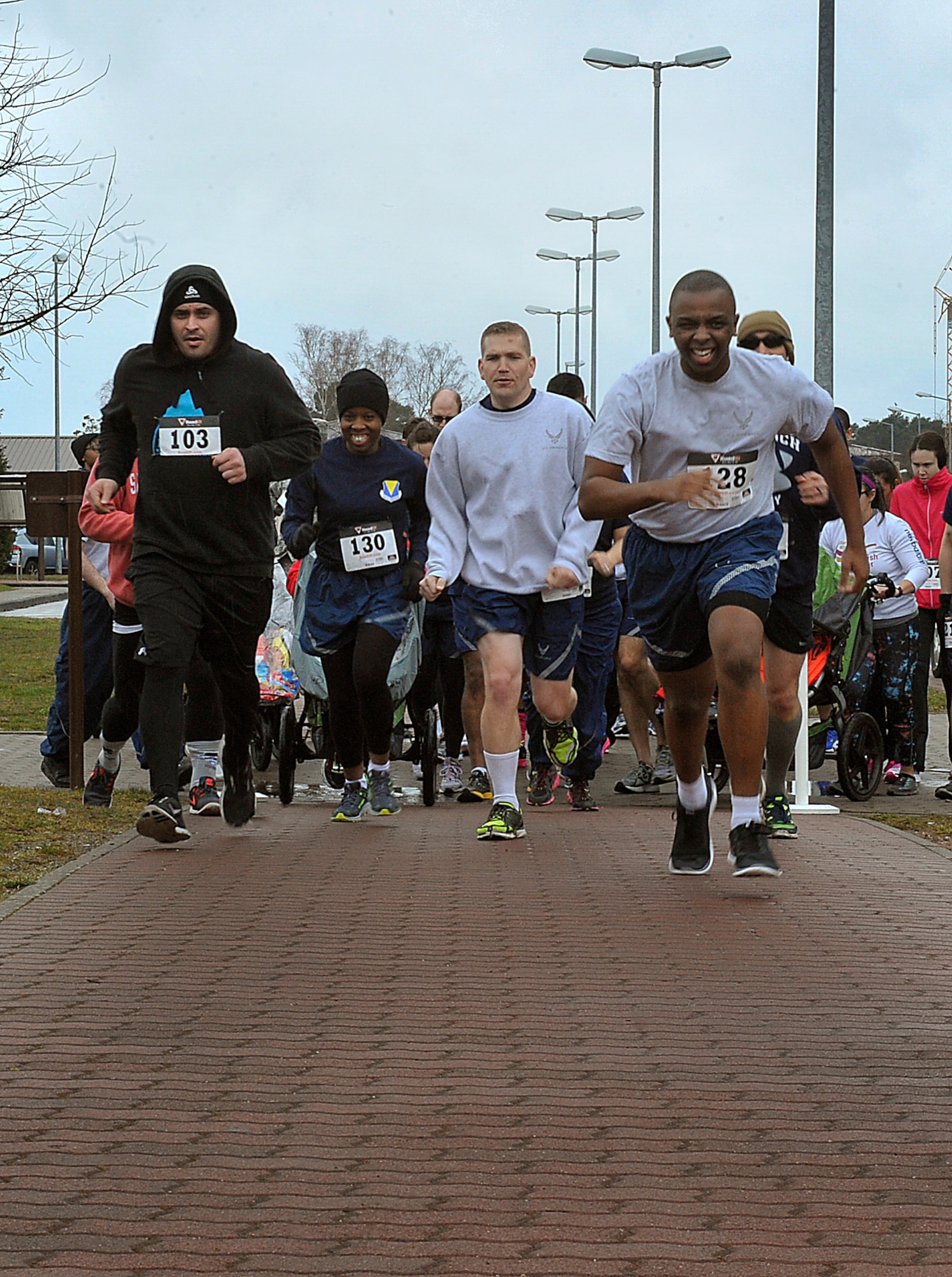 Participants cross the starting line during the first One Mile Walk in Her Heels and 5K Run March 25, 2016, at Ramstein Air Base, Germany. Participants commemorated women by either running in a 5K race or walking a mile in high-heeled shoes. (U.S. Air Force photo/Airman 1st Class Larissa Greatwood)
