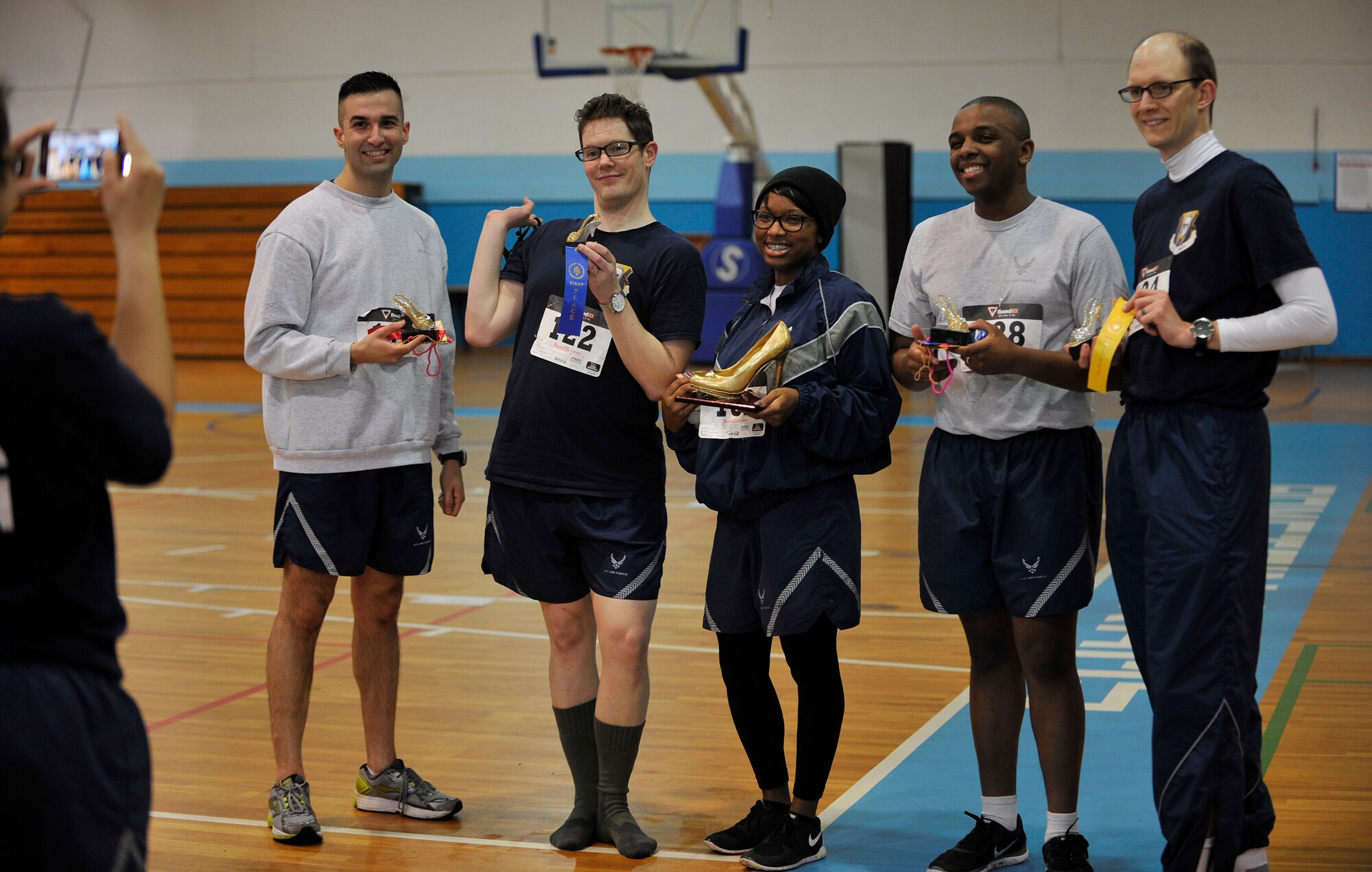 Airmen pose for a photo with their trophies after competing in the first One Mile Walk in Her Heels and 5K Run March 25, 2016, at Ramstein Air Base, Germany. Men and women participated in the event to show their support for women’s equality. (U.S. Air Force photo/Airman 1st Class Larissa Greatwood)
