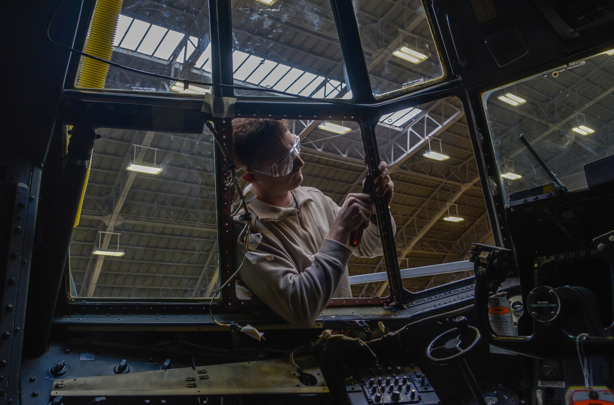 Airman 1st Class Chase Crider, 353rd Special Operations Maintenance crew chief, Kadena Air Base, Japan, removes sealant to install a new window on an MC-130 Talon II at Yokota Air Base, Japan, Feb. 26, 2016. The MC-130 and C-130 Hercules aircraft go through a 14 to 16-day isochronal inspection that is split into four phases: look phase, fix phase, inspection phase and the quality assurance phase. (U.S. Air Force photo by Senior Airman David Owsianka/Released)