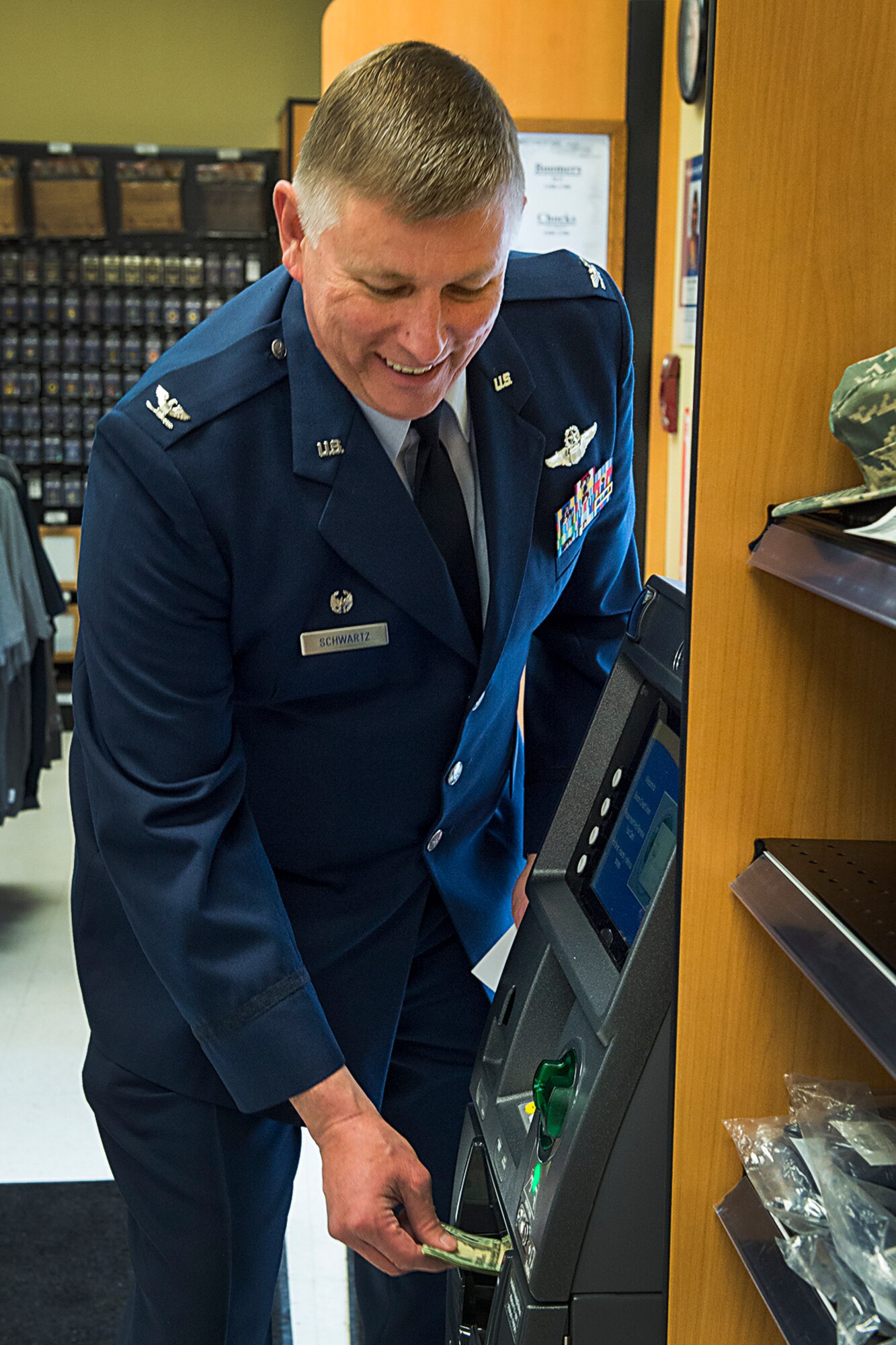 Col. Doug Schwartz, 434th Air Refueling Wing commander, withdraws money from the new automatic teller machine March 25, 2016 at the Grissom Exchange. The machine is available during store operating hours during the week and on unit training assemblies. (U.S. Air Force photo/Tech. Sgt. Benjamin Mota)