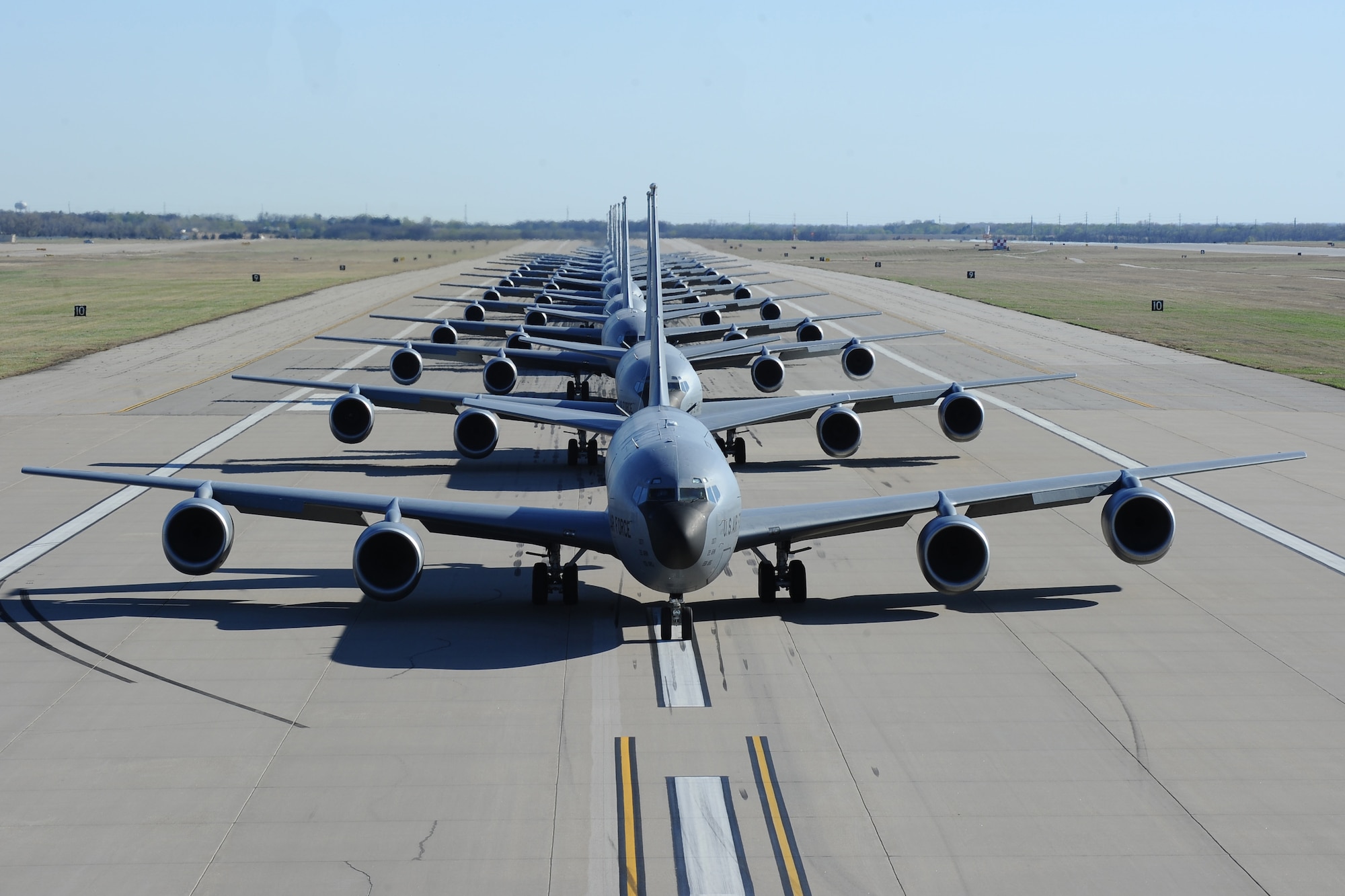 Fourteen KC-135 Stratotankers line up during a simulated alert call, March 24, 2016, at McConnell Air Force Base, Kan. The elephant walk was part of an exercise, which displayed the rapid mobility capabilities and teamwork of the men and women at McConnell to take flight within minutes of being notified of a mission. (U.S. Air Force photos/Airman 1st Class Christopher Thornbury) 