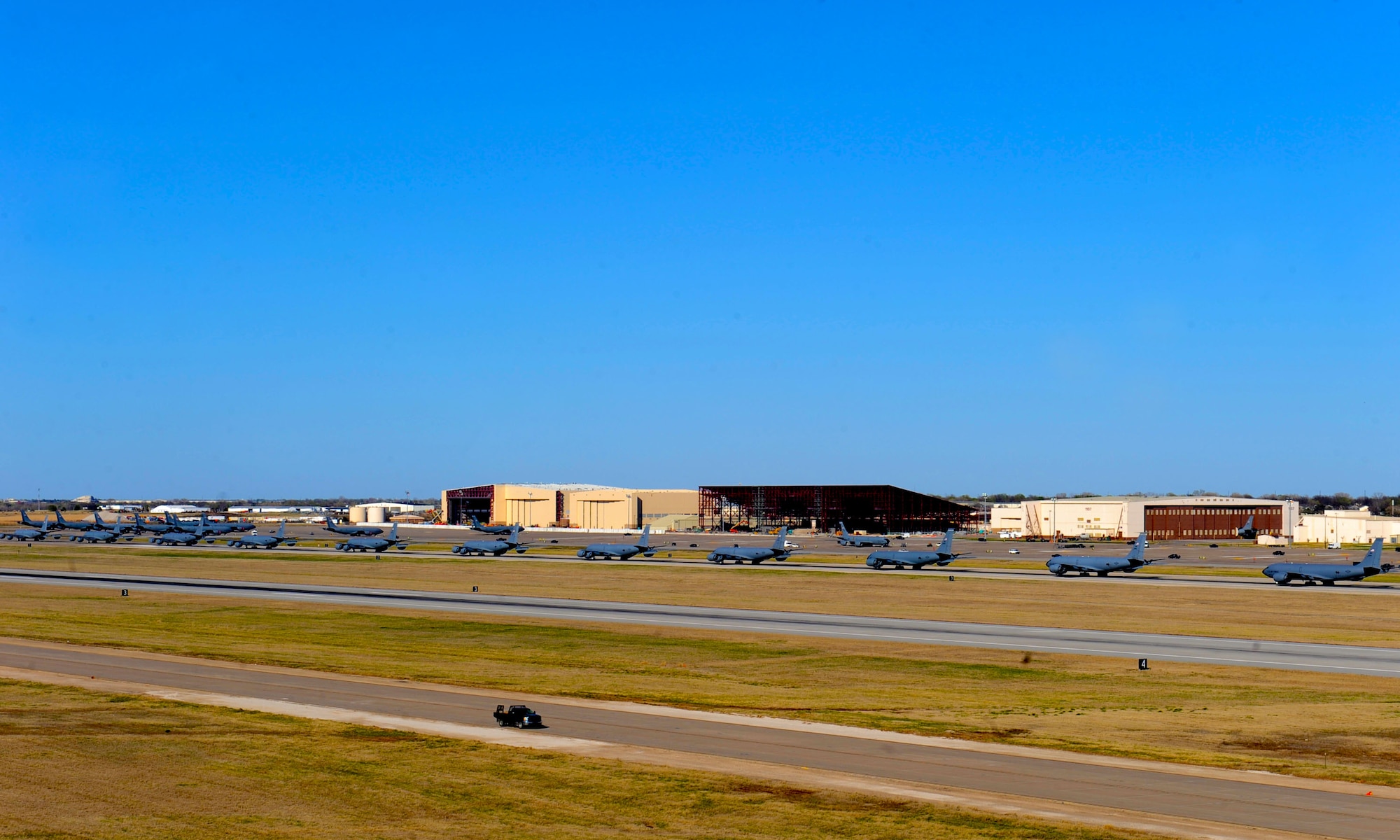 Fourteen KC-135 Stratotankers line up during a simulated alert call, March 24, 2016, at McConnell Air Force Base, Kan. The elephant walk was part of an exercise, which displayed the rapid mobility capabilities and teamwork of the men and women at McConnell to take flight within minutes of being notified of a mission. (U.S. Air Force photos/Senior Airman David Bernal Del Agua) 