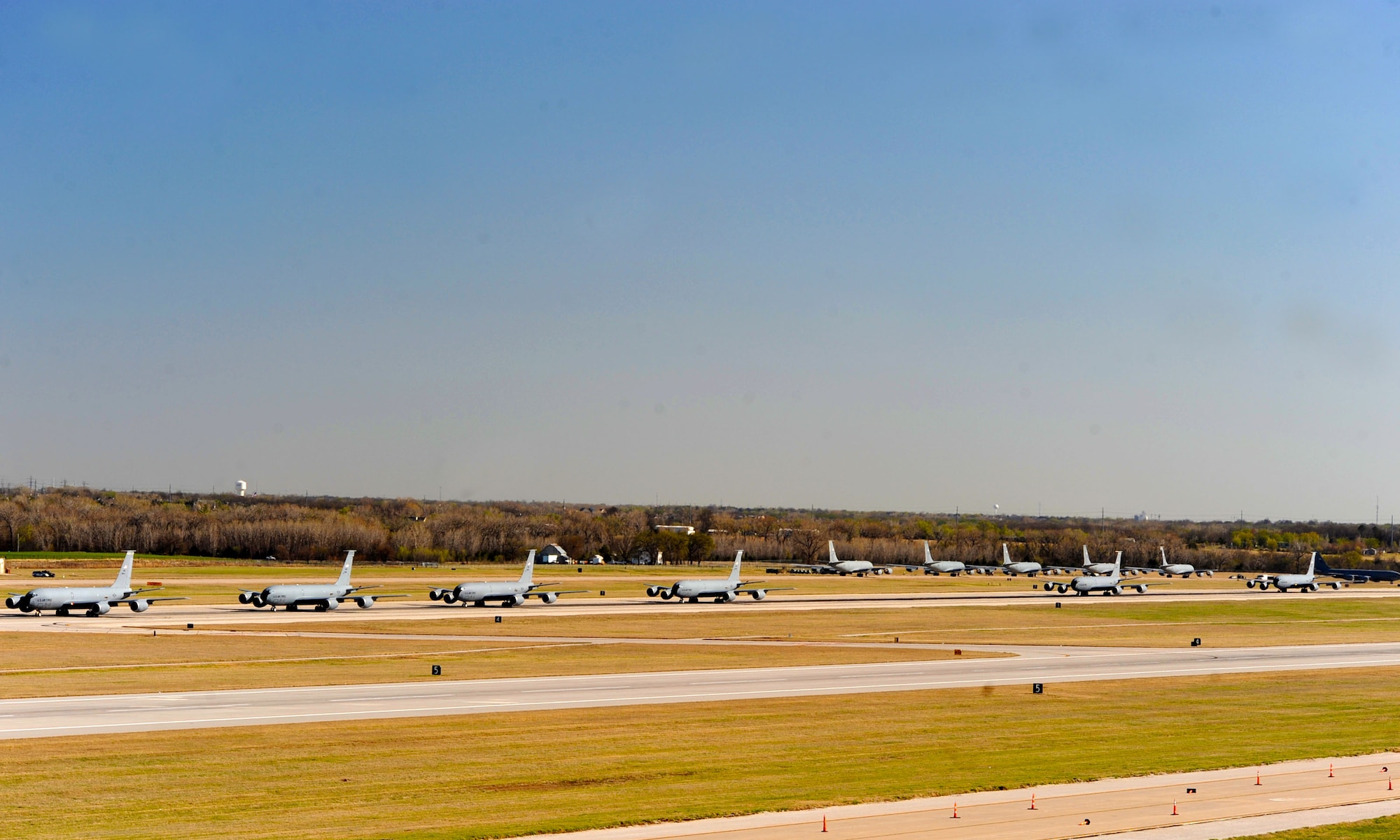 Fourteen KC-135 Stratotankers line up during a simulated alert call, March 24, 2016, at McConnell Air Force Base, Kan. The elephant walk was part of an exercise, which displayed the rapid mobility capabilities and teamwork of the men and women at McConnell to take flight within minutes of being notified of a mission. (U.S. Air Force photos/Senior Airman David Bernal Del Agua) 