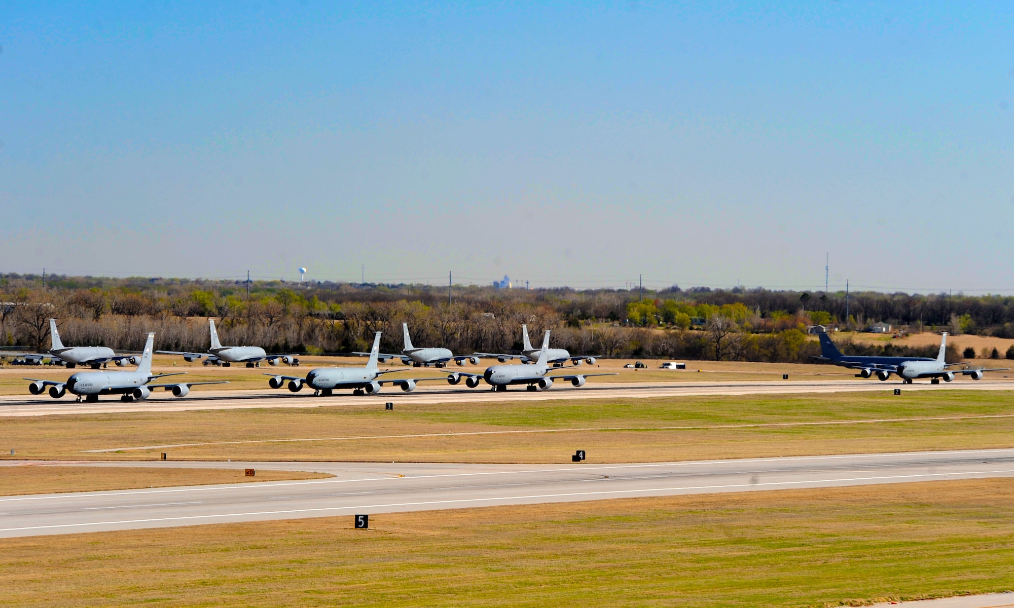 Fourteen KC-135 Stratotankers line up during a simulated alert call, March 24, 2016, at McConnell Air Force Base, Kan. The elephant walk was part of an exercise, which displayed the rapid mobility capabilities and teamwork of the men and women at McConnell to take flight within minutes of being notified of a mission. (U.S. Air Force photos/Senior Airman David Bernal Del Agua) 
