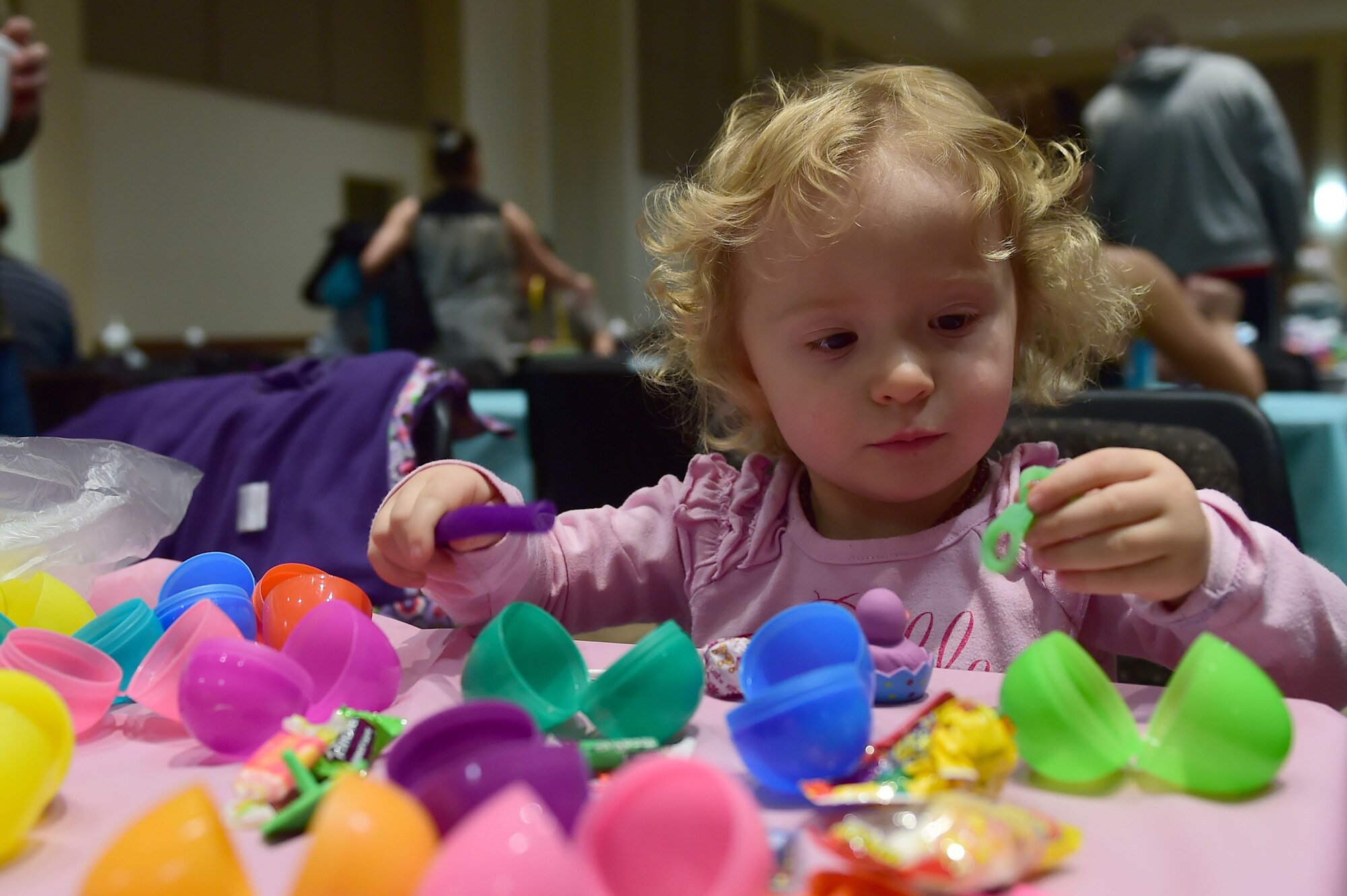 Emma Kohler discovers a surprise in her Easter egg March 26, 2016, at the Leadership Development Center on Buckley Air Force Base, Colo. Emma along with many other children received dozens of Easter eggs which held different treats.(U.S. Air Force photo by Airman 1st Class Luke W. Nowakowski/Released) 