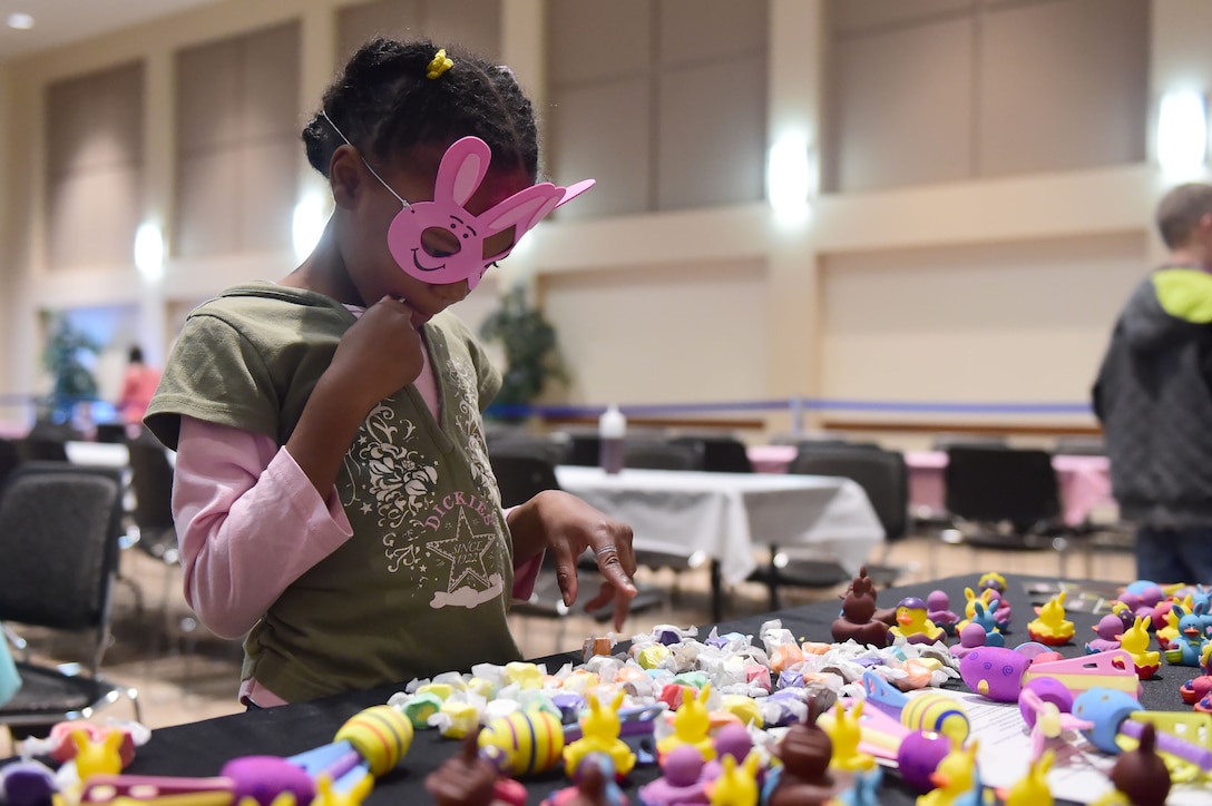 A child from the Buckley Air Force Base community picks out an Easter treat March 26, 2016, at the Leadership Development Center on Buckley AFB, Colo. Families enjoyed the free pancake breakfast along with hundreds of Easter treats.(U.S. Air Force photo by Airman 1st Class Luke W. Nowakowski/Released)
