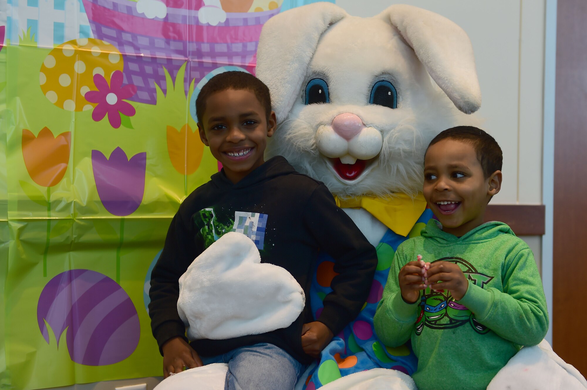 (left) Xavier Howard and Jeffrey Howard III get their photo taken with the Easter Bunny March 26, 2016, at the Leadership Development Center on Buckley Air Force Base, Colo. Families celebrated by attending the annual Breakfast with Bunny event which included breakfast and hundreds of Easter eggs filled with treats. (U.S. Air Force photo by Airman 1st Class Luke W. Nowakowski/Released)
