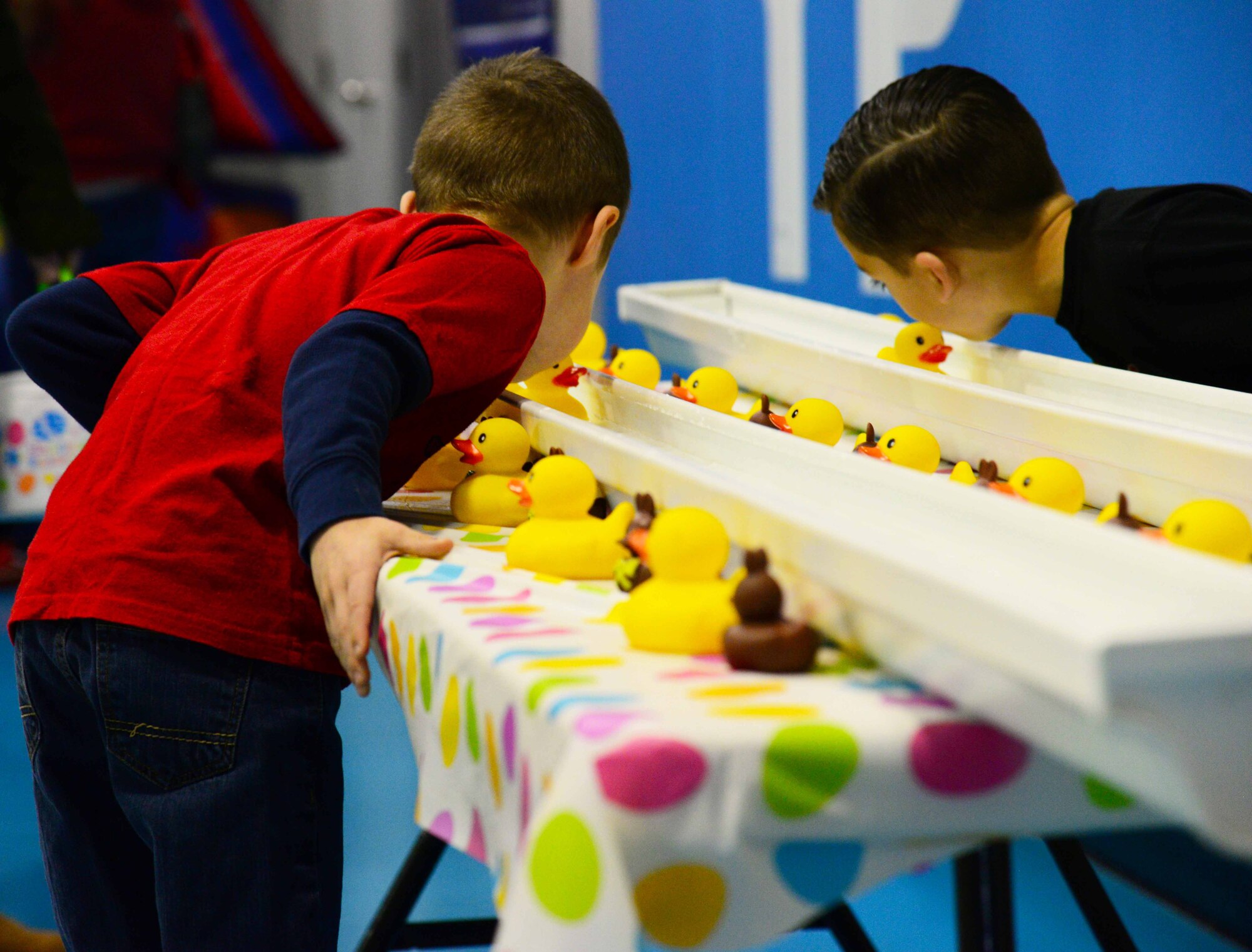 Two children compete in a game at the spring carnival March 26, 2016, at the Youth Center at Malmstrom Air Force Base, Mont. The carnival offered a variety of activities for Malmstrom’s children and families to participate in including carnival games, cotton candy booths and face painting. (U.S. Air Force photo/Airman 1st Class Magen M. Reeves)